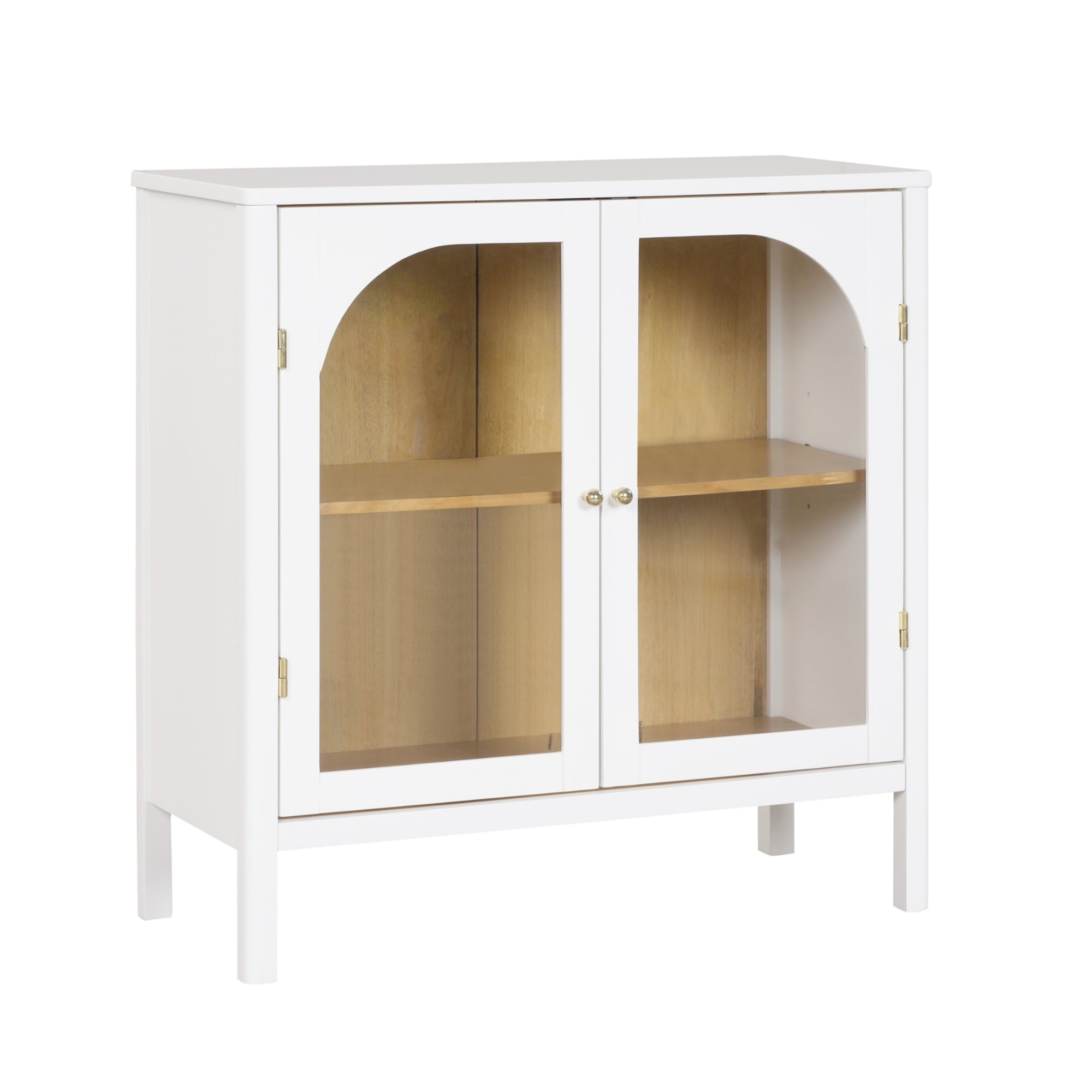A white wooden cabinet with two glass doors, gold knobs, and a light wood interior shelf. The doors feature arched glass panels. The cabinet has a simple, modern design and stands on four legs.