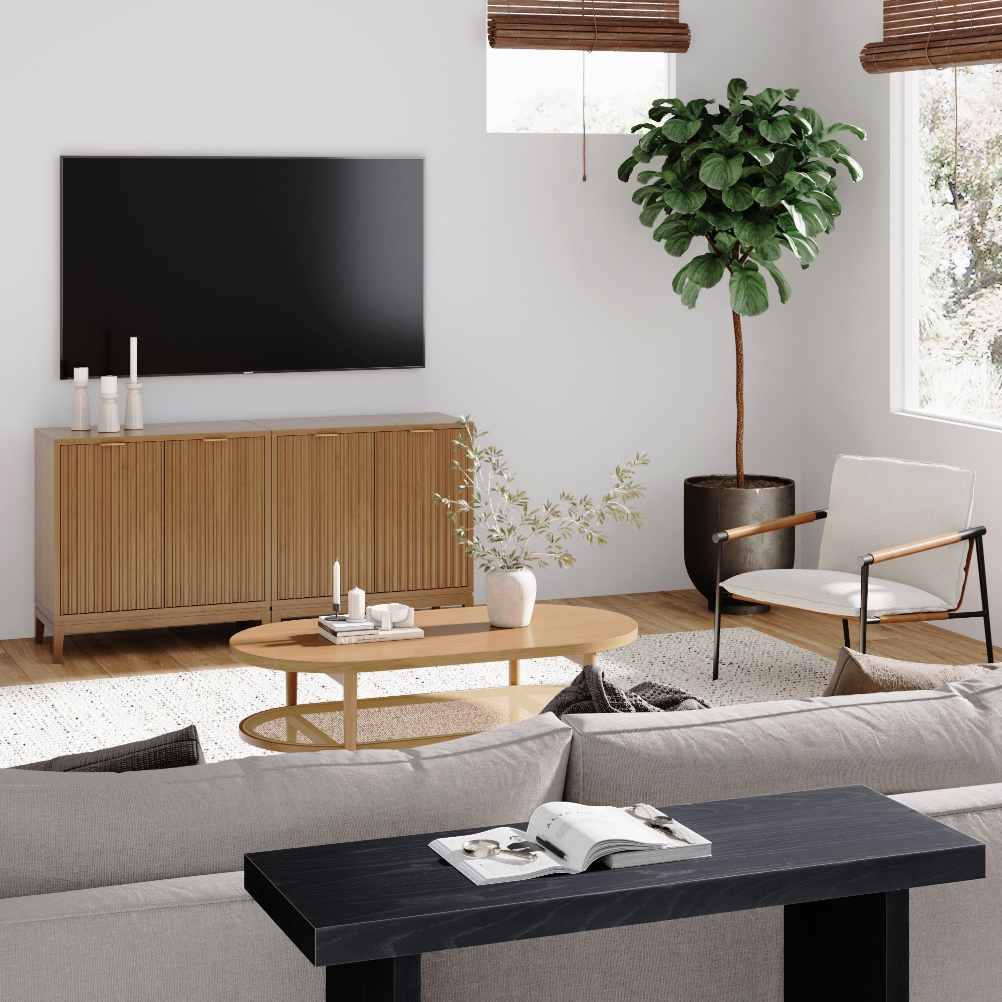 A modern living room with a sofa, wooden coffee table, TV on the wall, sideboard, potted plant, armchair, and large windows with blinds letting in natural light. A black console table holds an open book.