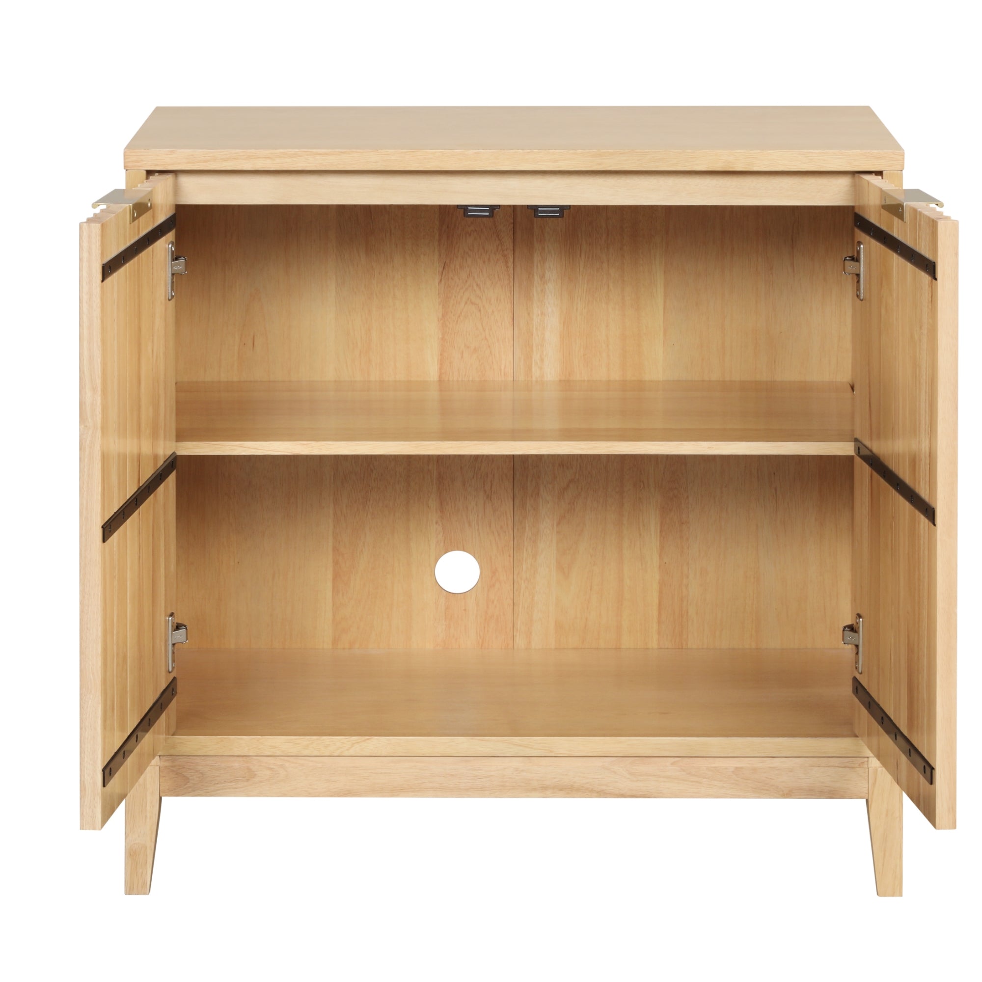 Light wood cabinet with both doors open, revealing two interior shelves and a round hole in the back panel for cable management. The cabinet has a simple, modern design and stands on four legs.