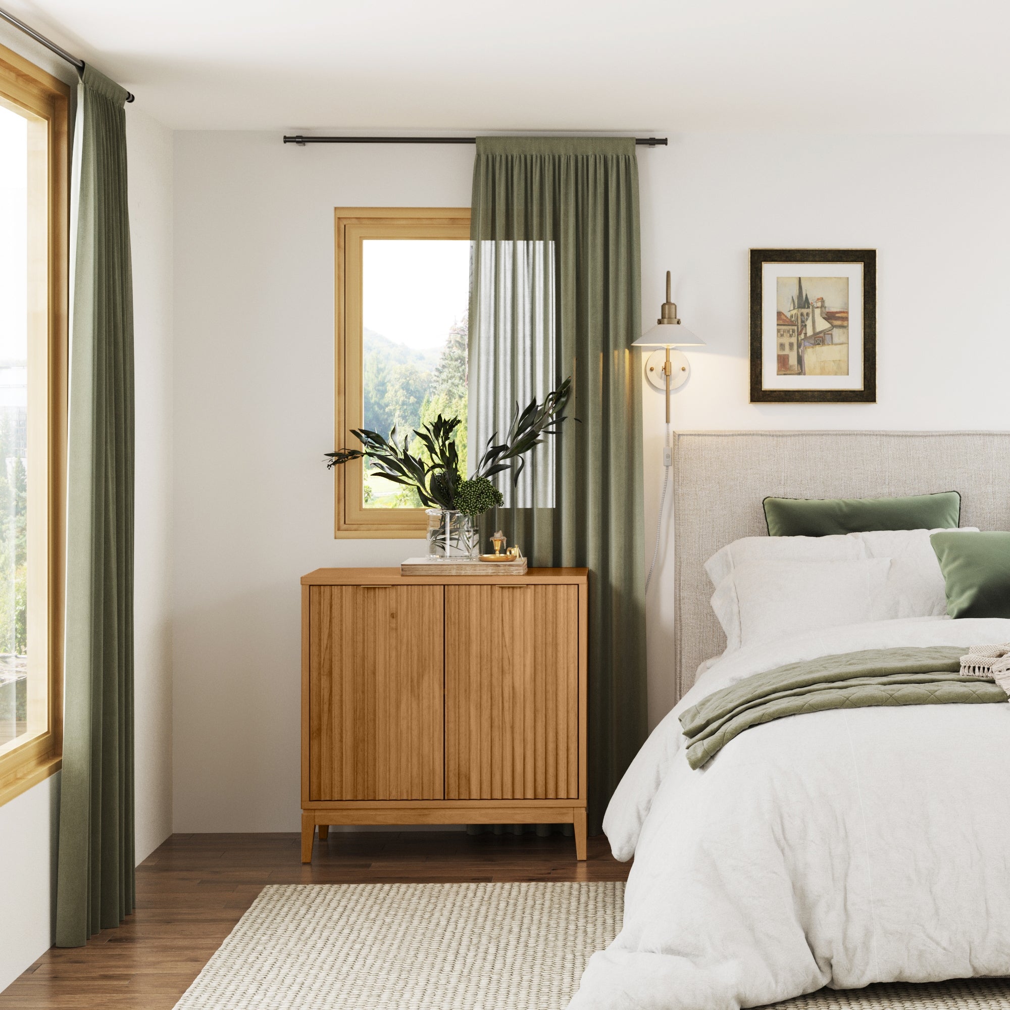 A cozy bedroom with a bed, green and white bedding, a wooden cabinet, a plant, wall art, and green curtains over windows; natural light fills the room, creating a calm, inviting atmosphere.