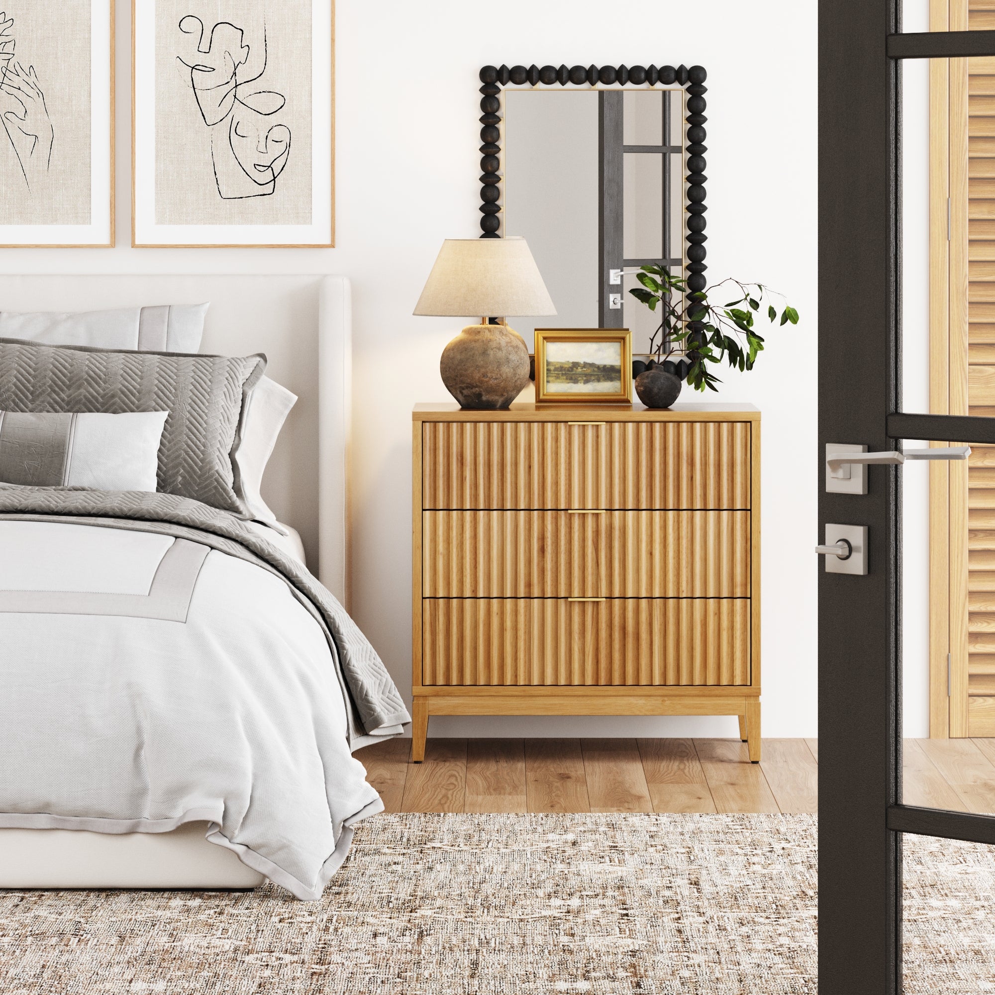 A modern bedroom with a neatly made bed, wooden dresser, mirror, lamp, framed art, and a plant. Neutral colors, soft textures, and natural light create a calm, stylish atmosphere.
