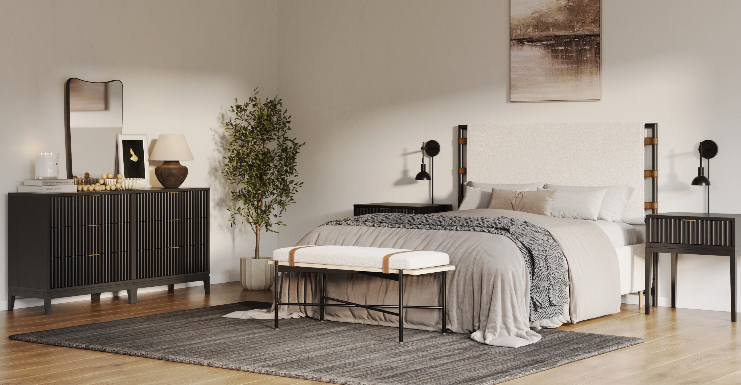 Modern bedroom with a large bed, neutral bedding, two black nightstands, a padded bench, dresser with a mirror, potted plant, table lamp, and wall art, all on a gray rug with wooden floors.