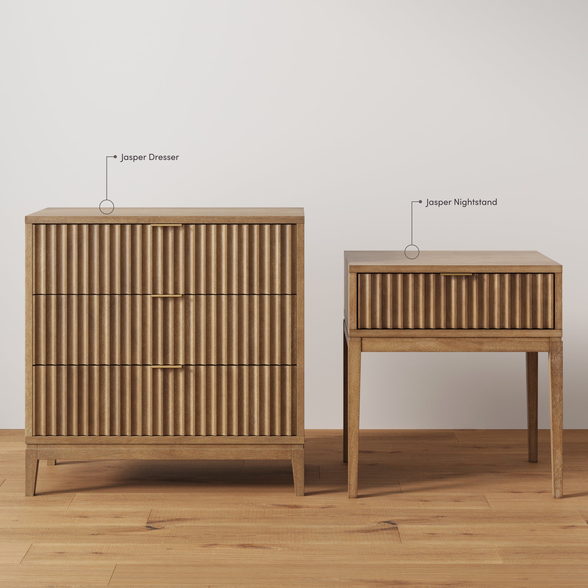 A wood dresser with three drawers stands next to a matching nightstand with one drawer, both featuring vertical grooves and tapered legs, labeled as Jasper Dresser and Jasper Nightstand.