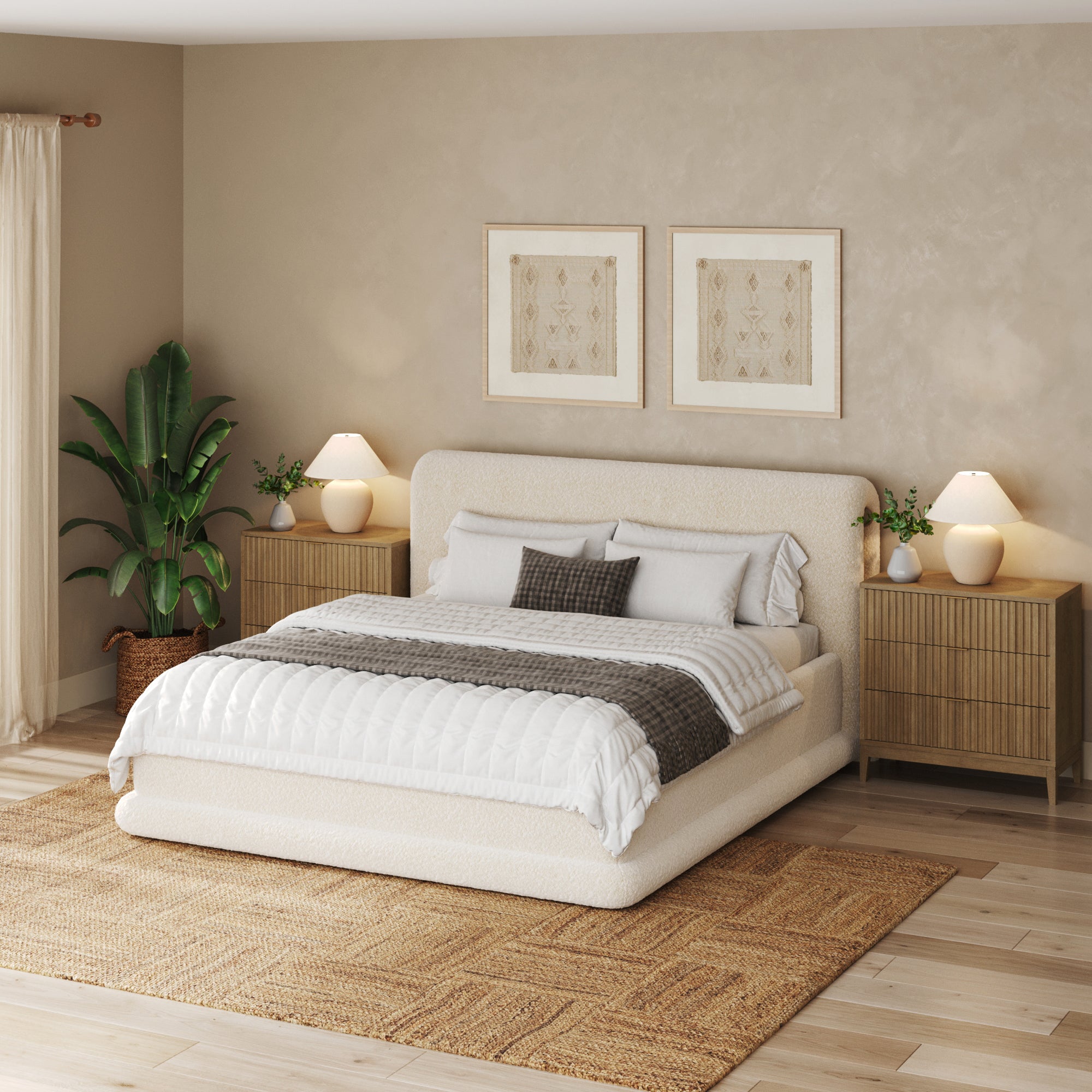 A modern boho bedroom with a large bed, white bedding, gray pillows, matching nightstands with lamps, a Nathan James Bohemian Solid Wood 3-Drawer Fluted Dresser in light brown, green potted plant, framed art, and a woven rug on wood floors.