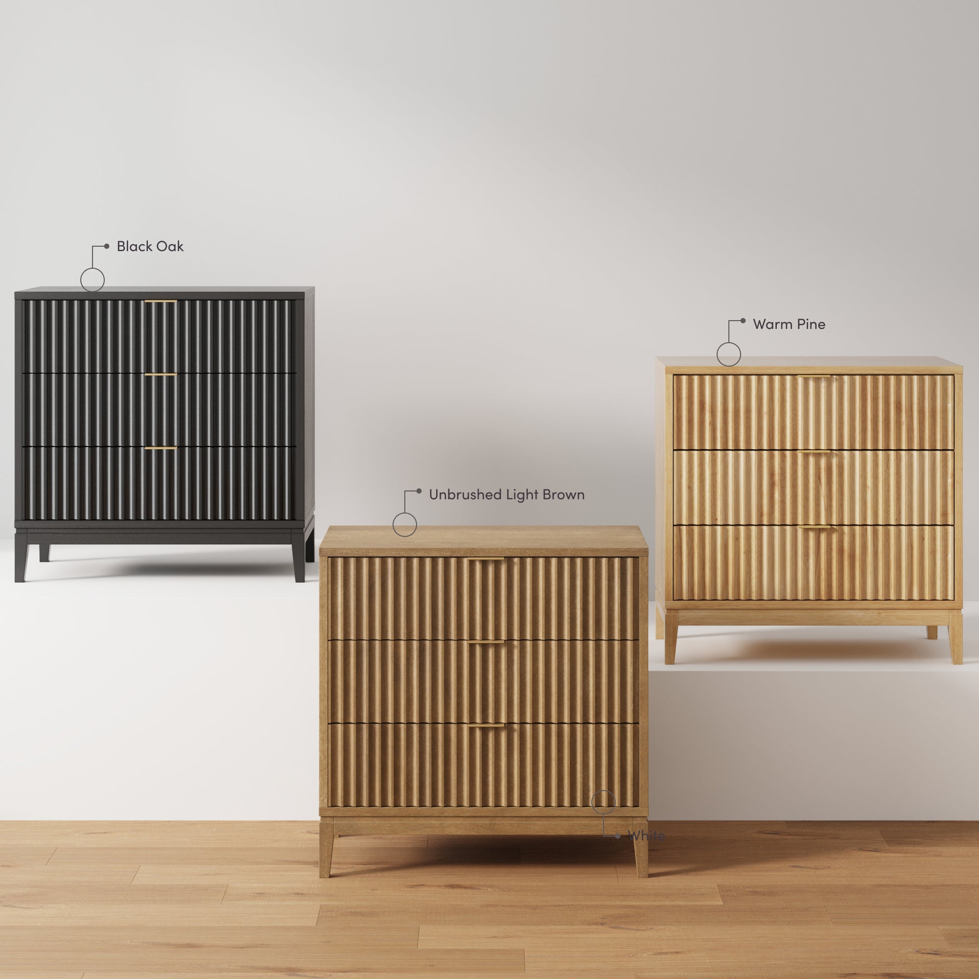 Three wooden dressers with vertical grooves are displayed: one in black oak, one in unbrushed light brown, and one in warm pine, all standing on a wooden floor against a plain white background.
