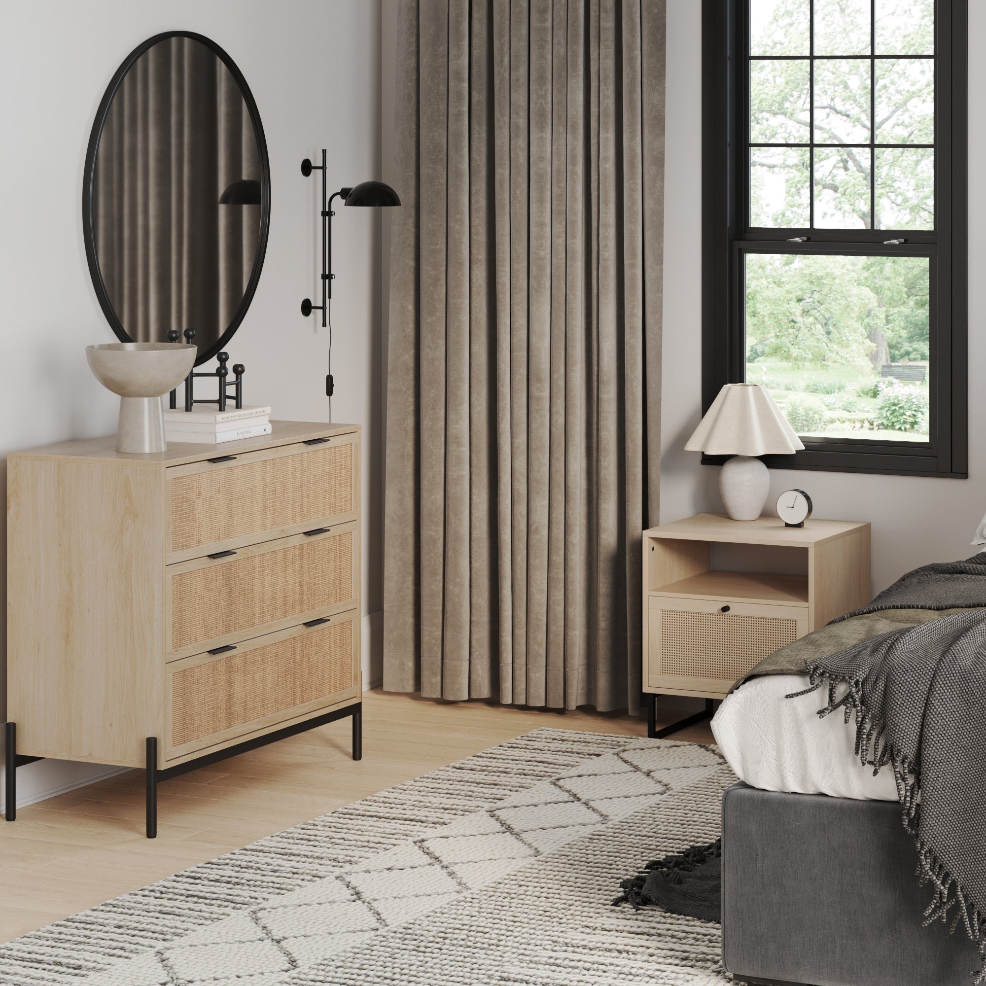 A modern bedroom showcases the Nathan James Bohemian Nightstand and Dresser Set, styled with a round mirror, lamp, decor, gray bedding, a patterned rug, tall curtains, and a large window offering green views.