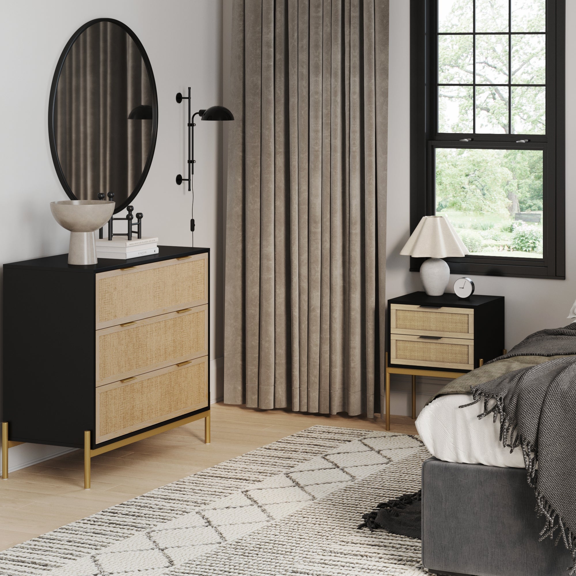 Modern bedroom with the Andrew Bedroom Set, a geometric rug, Nathan James Black & Gold Rattan Nightstand and Dresser Set, round mirror, table lamp, tall curtains, large window with greenery outside, and part of a gray bed visible.
