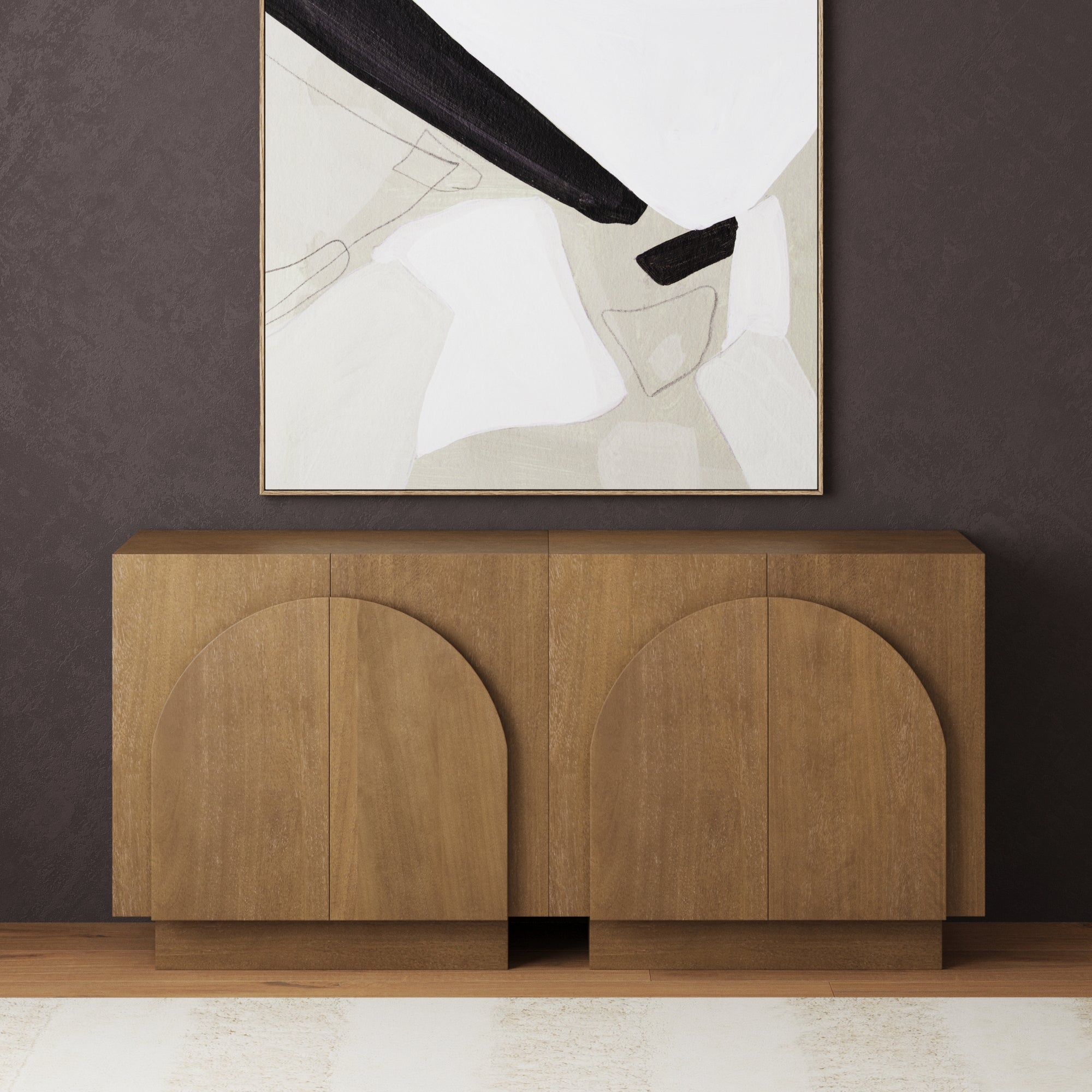 The Nathan James Arched TV Console Credenza Light Brown (Set of 2) sits against a dark brown textured wall, with an abstract painting in neutral tones featuring bold black and white shapes hanging above it.