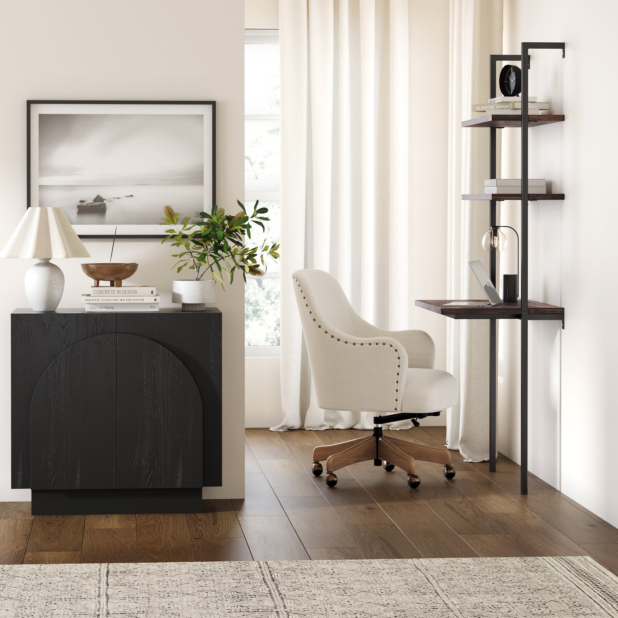 A modern home office with a white upholstered chair, a wall-mounted desk with shelves, a laptop, potted plant, lamp, and framed artwork on white walls, with sunlight streaming through sheer curtains.