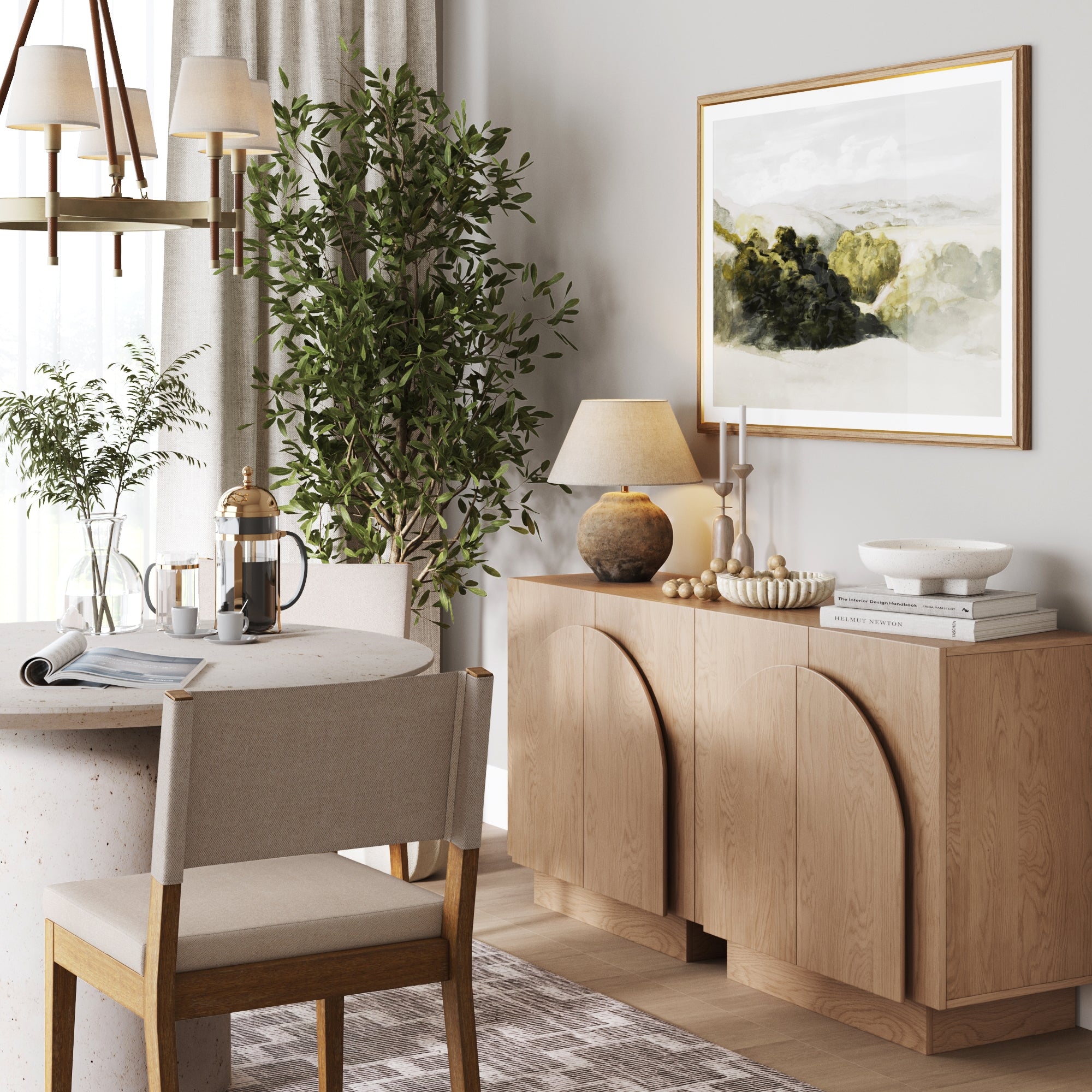 A cozy dining area features a light wood table and chairs, Nathan James Arched TV Console Credenza Oak (Set of 2) as storage, decor items, a potted plant, lamp, and framed wall art. Soft natural light creates a warm, inviting atmosphere.