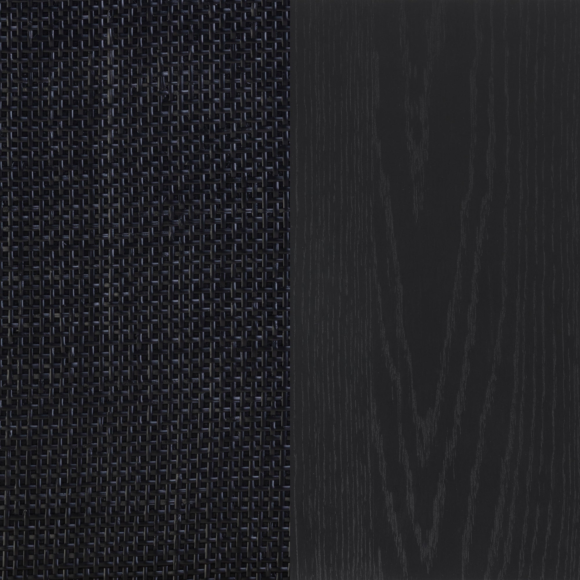 A close-up of two black surfaces: the left side shows a woven texture, while the right side displays a smooth surface with subtle wood grain patterns.
