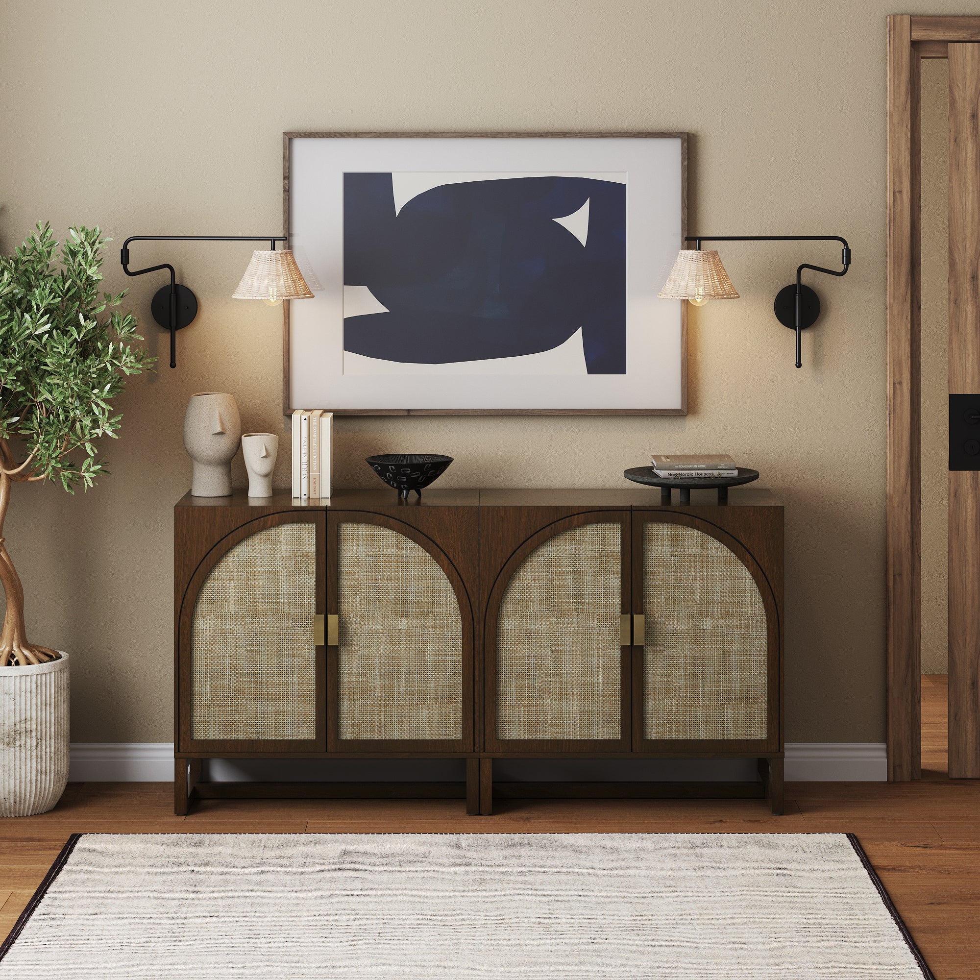 A modern entryway features two Nathan James Boho Arched TV Console Credenzas in dark acacia, decorative accents, a potted plant, abstract art above, and wall lamps on a beige wall with wood floors.
