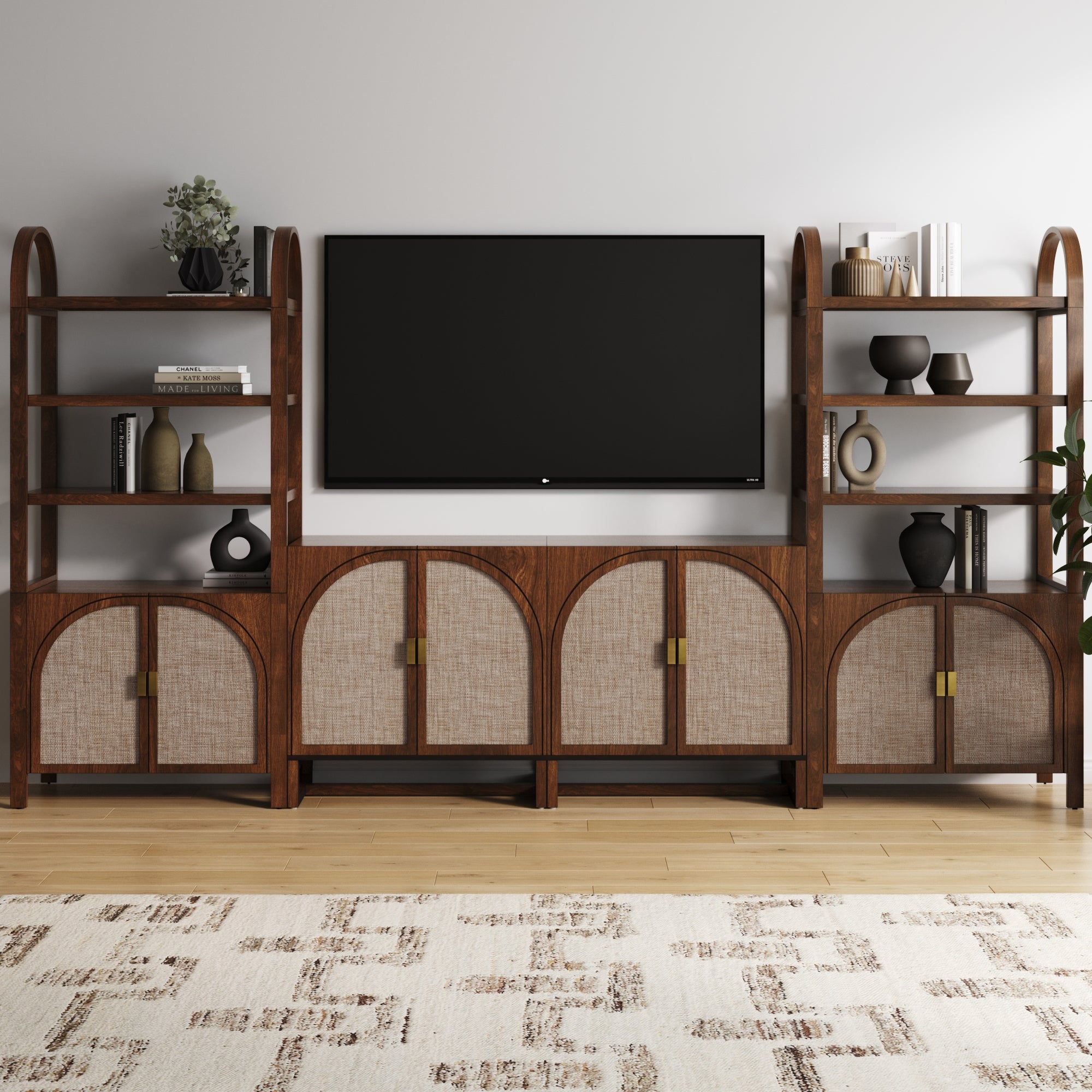 A modern entertainment center with dark wood and light woven cabinet doors sits against a white wall, featuring a large flat-screen TV, open shelves with decor, and a patterned rug on a light wood floor.