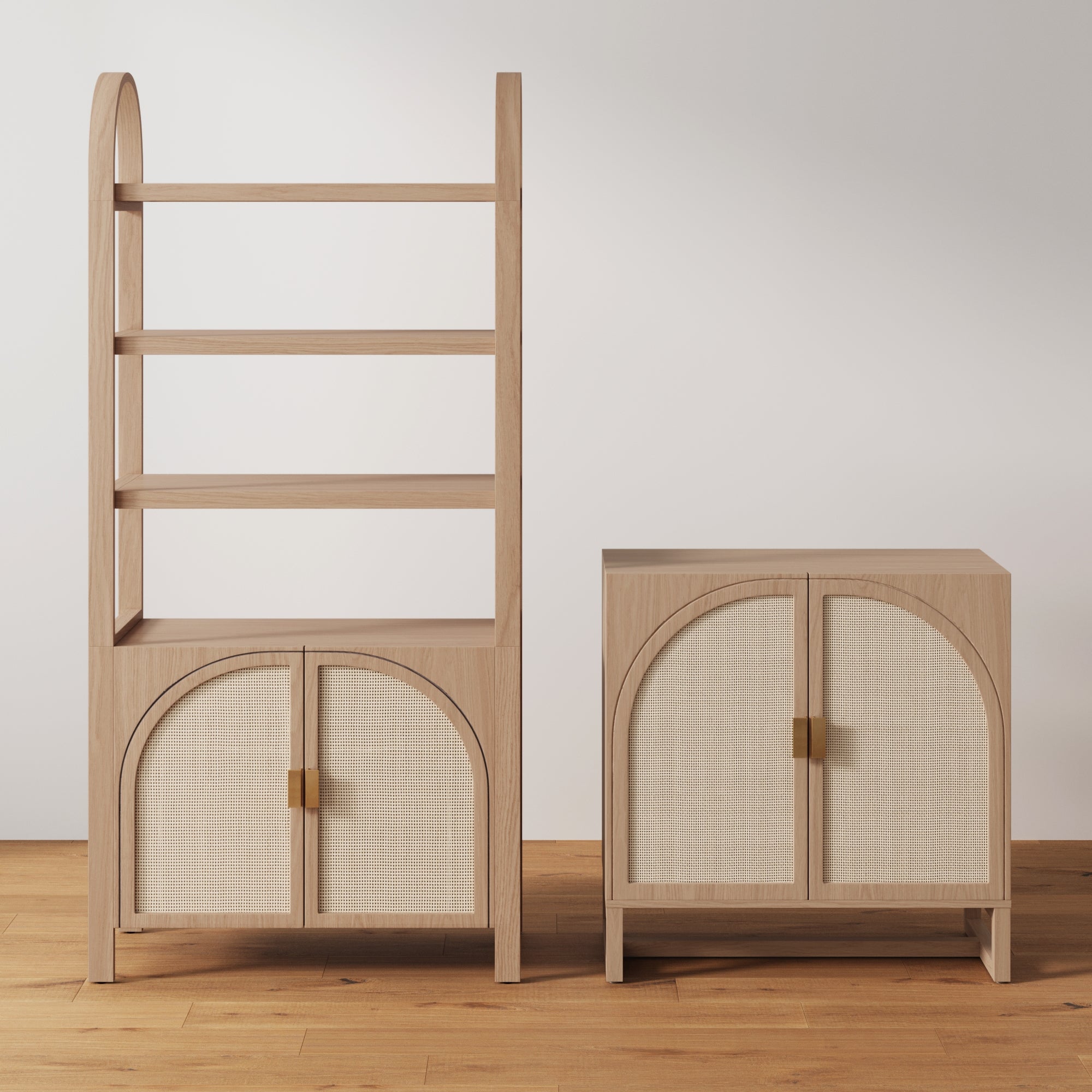 A wooden shelving unit with three open shelves and an arched-door cabinet below stands beside a matching cabinet with two arched doors, both on a wooden floor against a plain white wall.