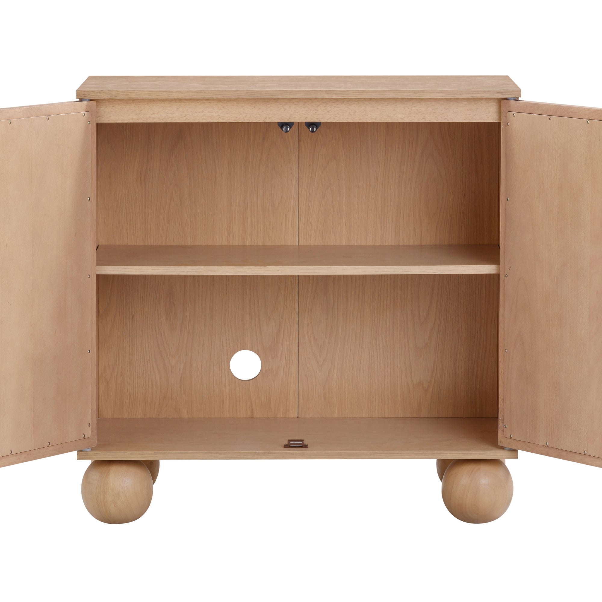 A light wood cabinet with two open doors, a single interior shelf, a round hole in the back panel for cables, and four large spherical legs. The cabinet interior is empty.