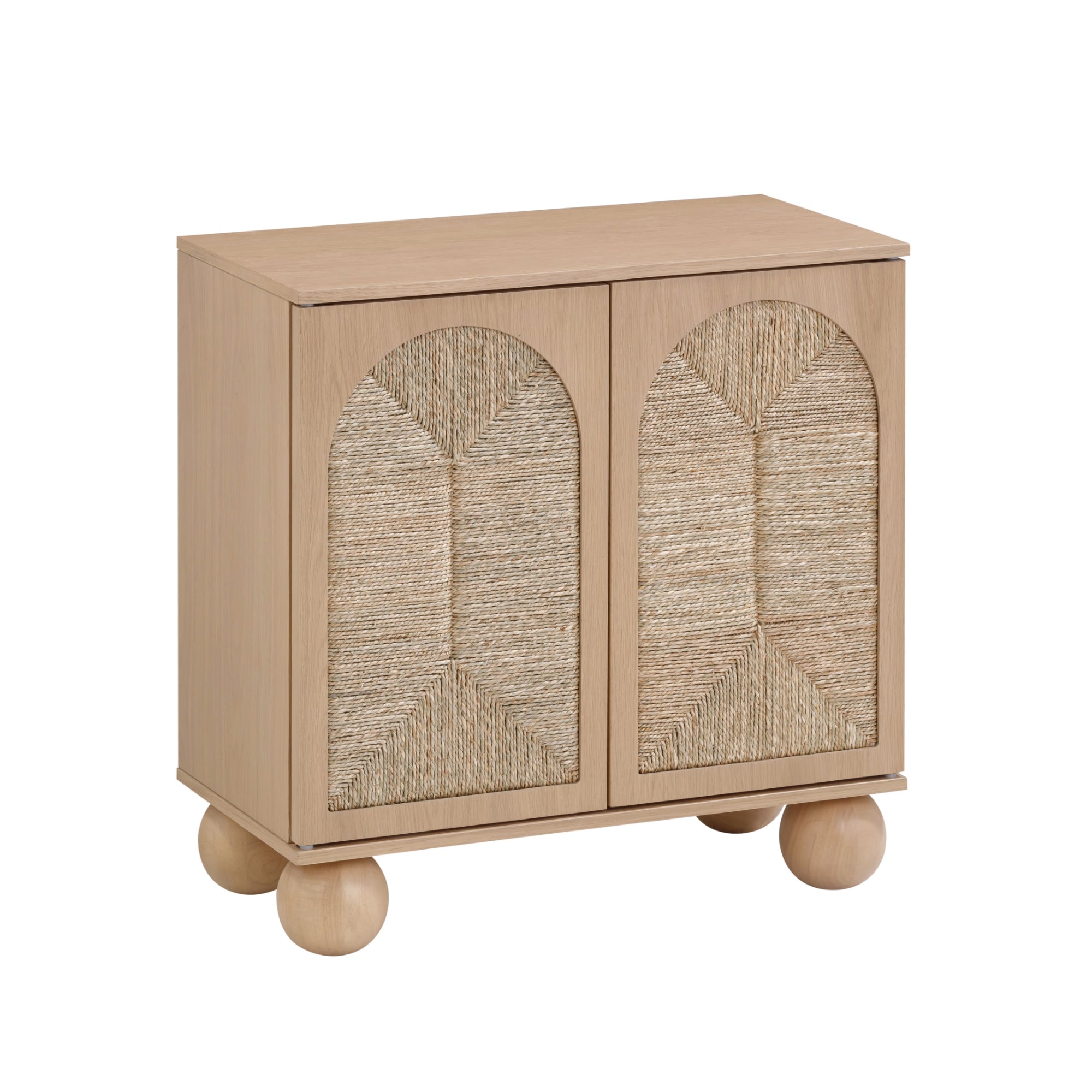 A small wooden cabinet with two doors featuring woven rattan panels in a geometric pattern, standing on four round ball-shaped legs.