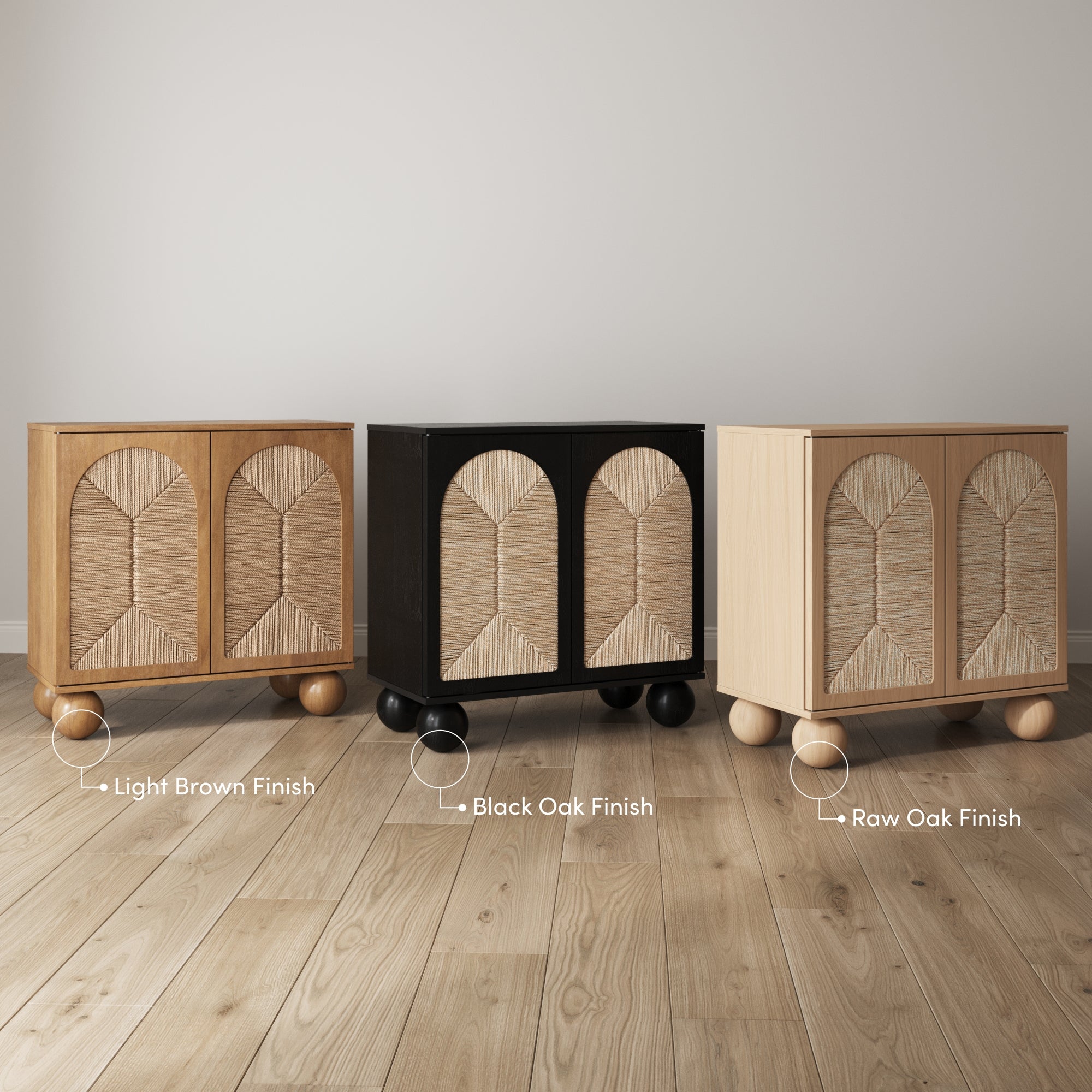 Three modern cabinets with round legs stand side by side on a wooden floor, each in a different finish: light brown, black oak, and raw oak, with textured cabinet doors and a neutral wall in the background.