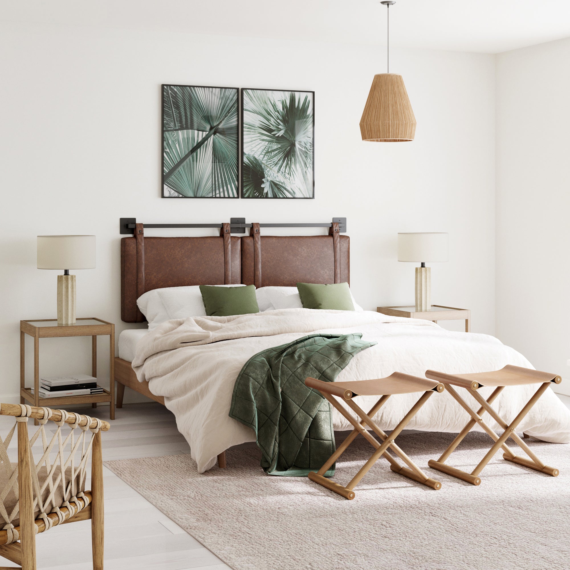 A modern bedroom with the Nathan James Upholstered King Wall Mount Headboard in brown, neutral bedding, green pillows, two bedside tables with lamps, a green throw blanket, palm leaf wall art, and natural wood accents.