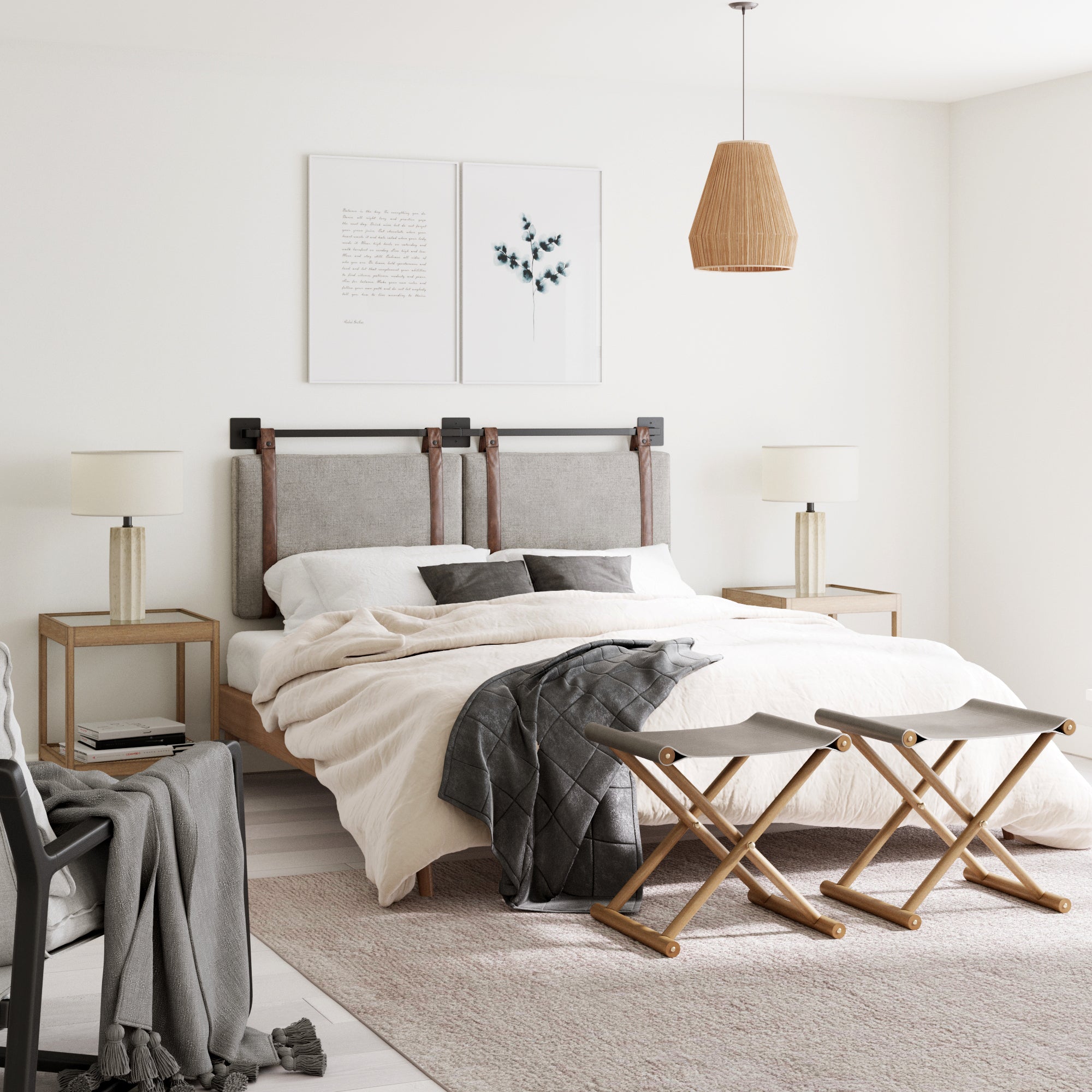 Modern bedroom with a neutral palette featuring a king bed with the Nathan James Upholstered King Wall Mount Headboard in gray, two bedside tables with lamps, a chair with gray throw, folding stools at the foot, and minimalist wall art above the bed.