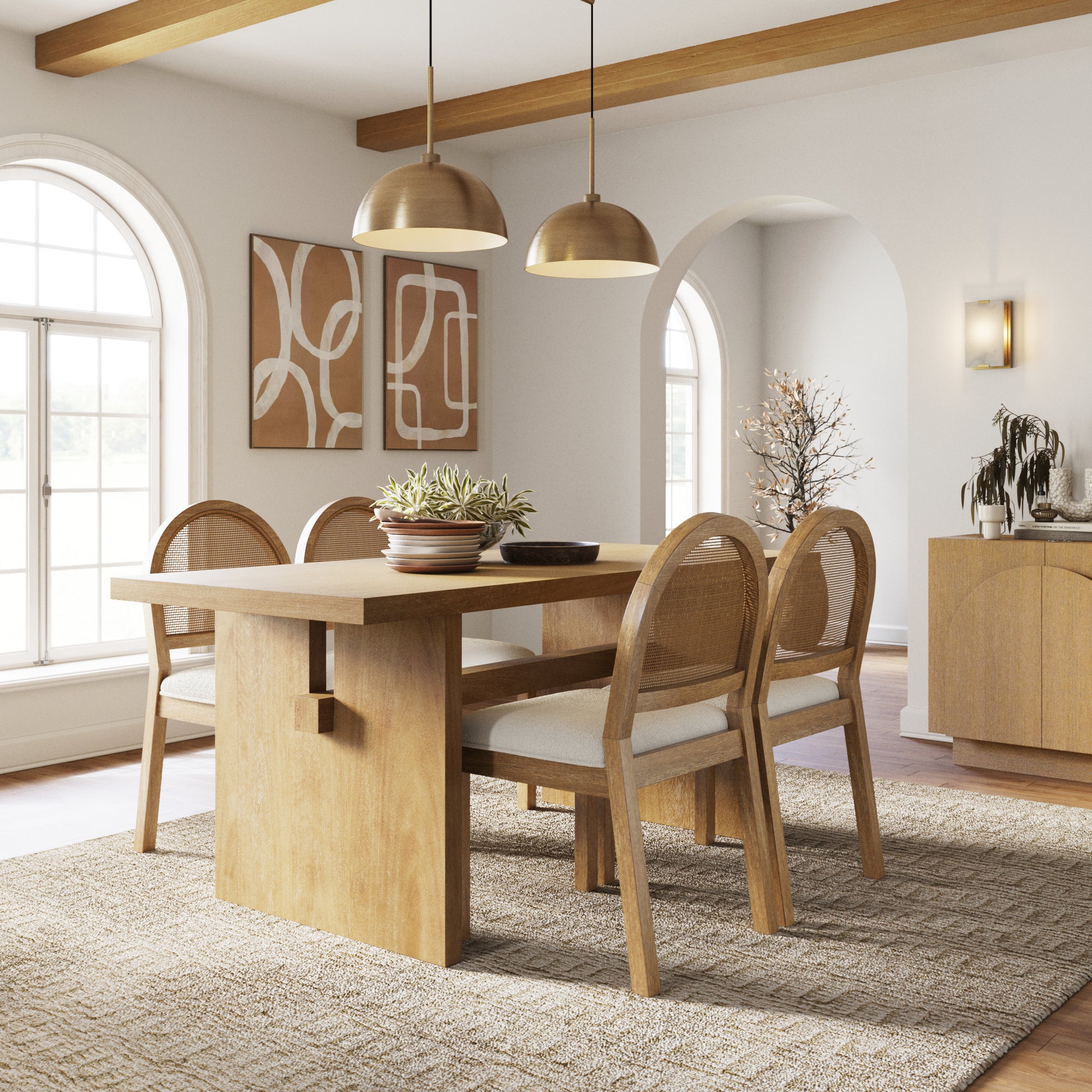 A modern dining room with the Nathan James Bohemian Cane Dining Set (4 Chairs), featuring a wood veneer table, rattan chairs, pendant lights, abstract wall art, arched windows, and warm neutral décor.