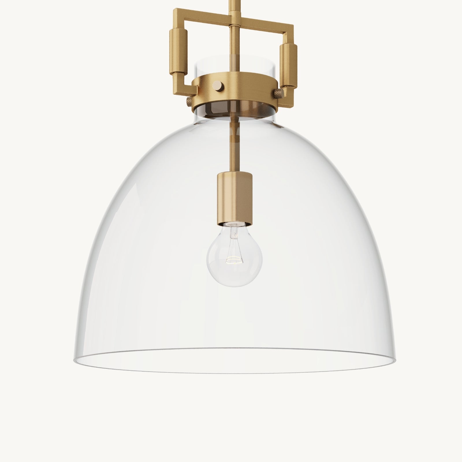 A modern pendant light with a clear glass dome shade, brass accents, and an exposed light bulb, set against a plain white background.
