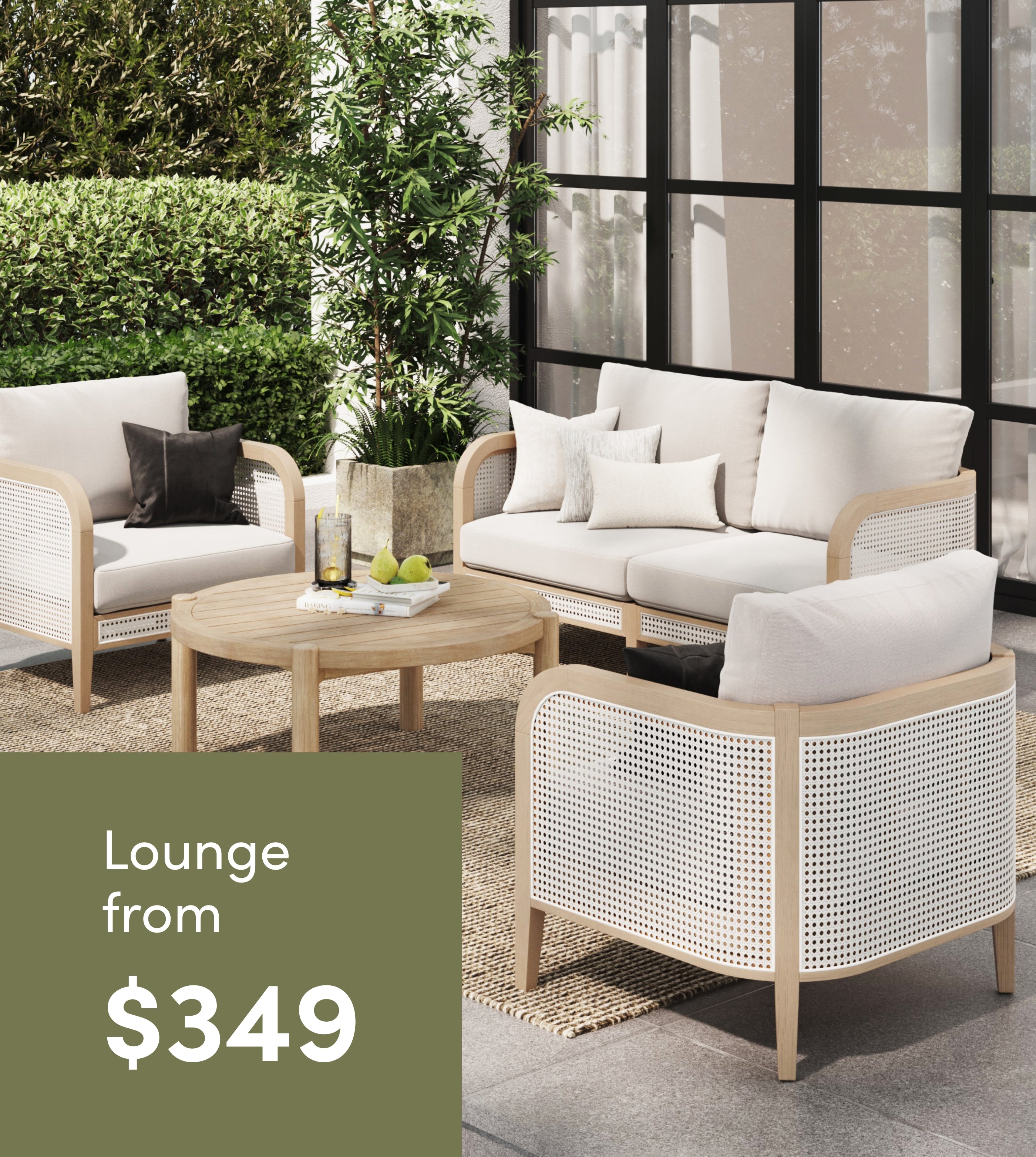 Outdoor patio set with a sofa, two armchairs, a coffee table, and neutral cushions on a rug. Leafy plants and large windows in the background. Text overlay reads: “Lounge from $349.”.