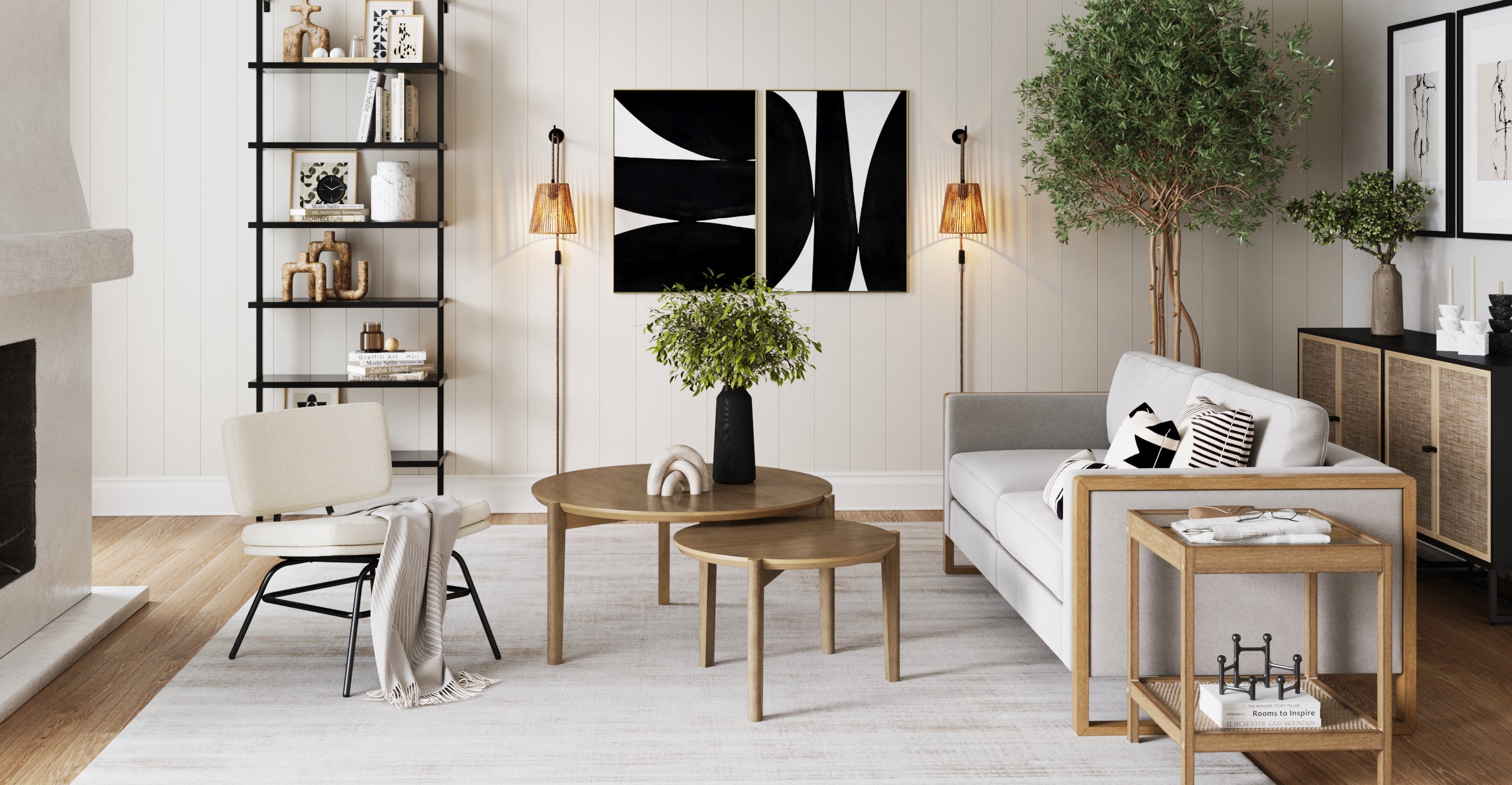 Modern living room with neutral tones, featuring a gray sofa, wooden tables, an accent chair, plants, black-and-white wall art, a black shelving unit, and warm lighting. Decor is minimal and contemporary.