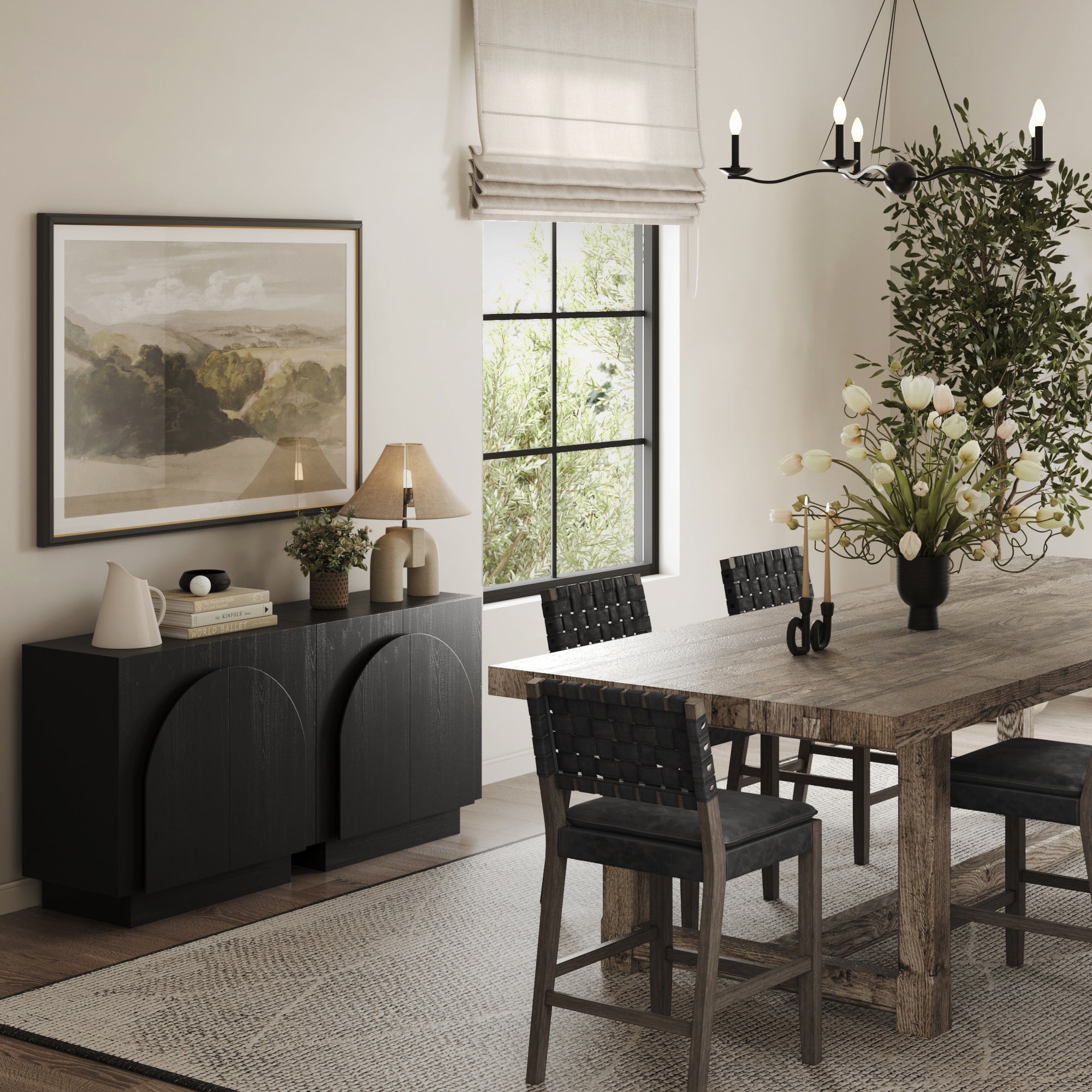 A modern dining room with a wooden table, black woven chairs, two Nathan James Arched TV Console Credenzas in black, a table lamp, large landscape artwork, a window with a roman shade, a rug, and decorative plants.
