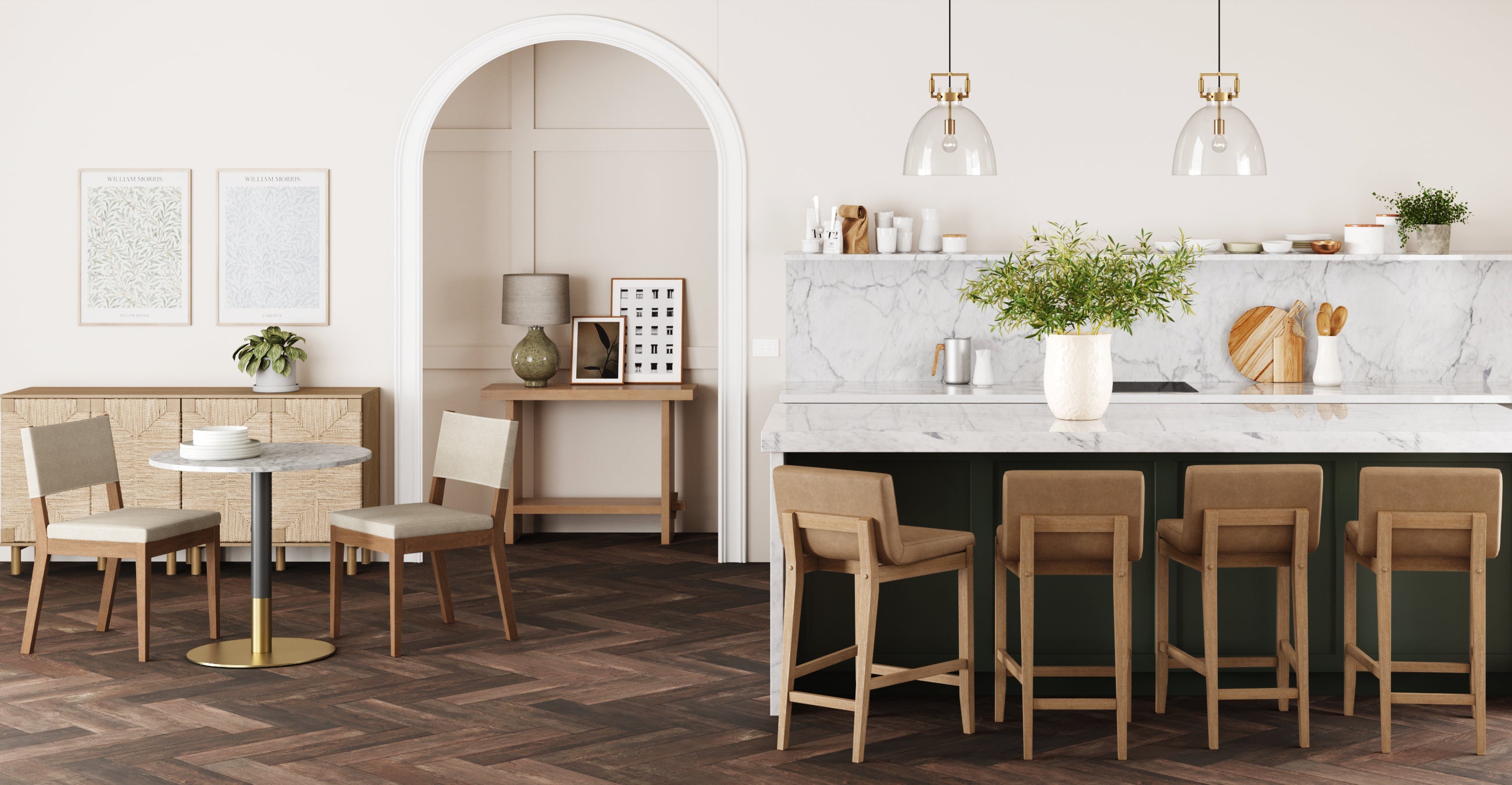 A modern kitchen with a marble island, tan barstools, pendant lights, and a vase of greenery. In the background, there’s a small round table, chairs, artwork, and cabinets on a herringbone wood floor.