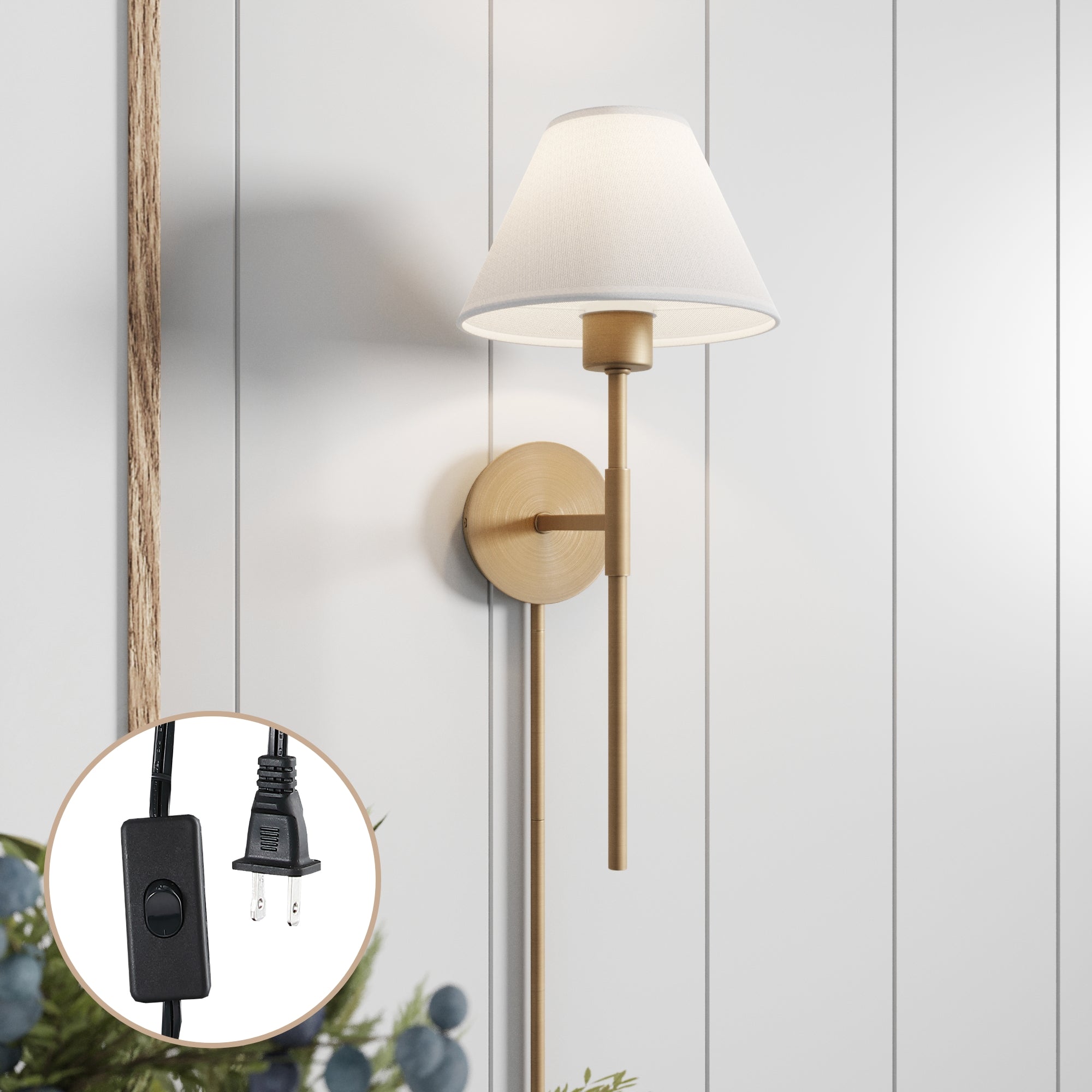 The Nathan James Plug-in Cotton Shade Wall Light features a brushed gold base and white shade, mounted on a white paneled wall. An inset highlights the lamp’s cord with black plug and on/off switch.