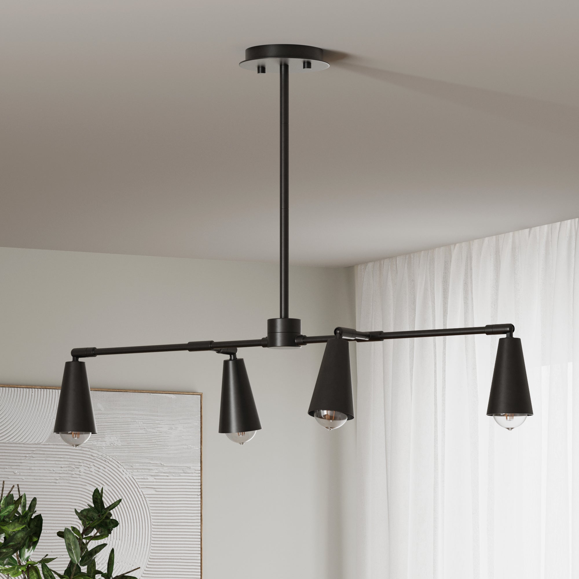 Nathan James black metal track light with 4 bulbs hung on ceiling in a room with white walls