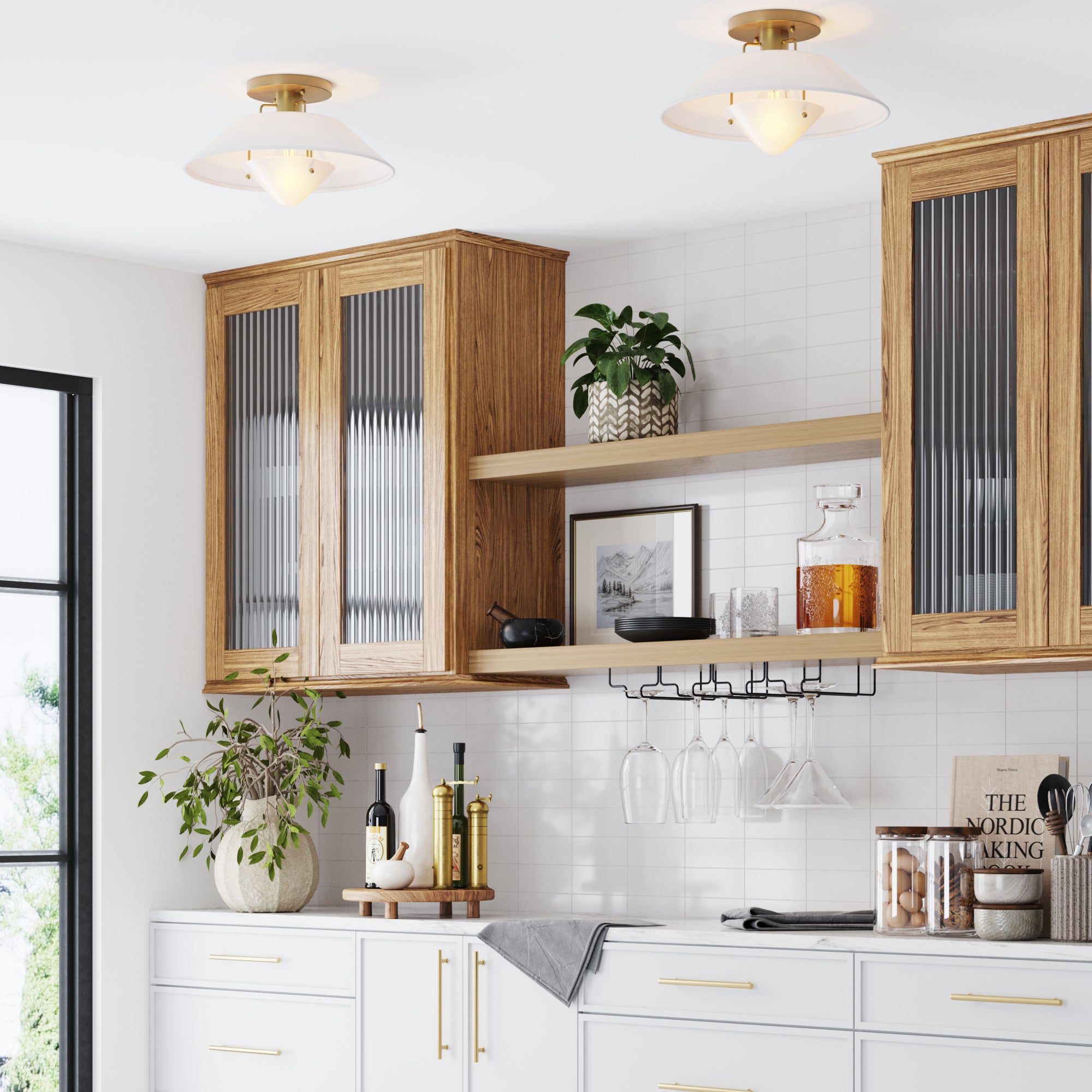 Modern kitchen with wood cabinets, glass-front doors, a white backsplash, plants, glassware, books, and decorative items on open shelves, under two ceiling lights. Natural light enters from a large window on the left.