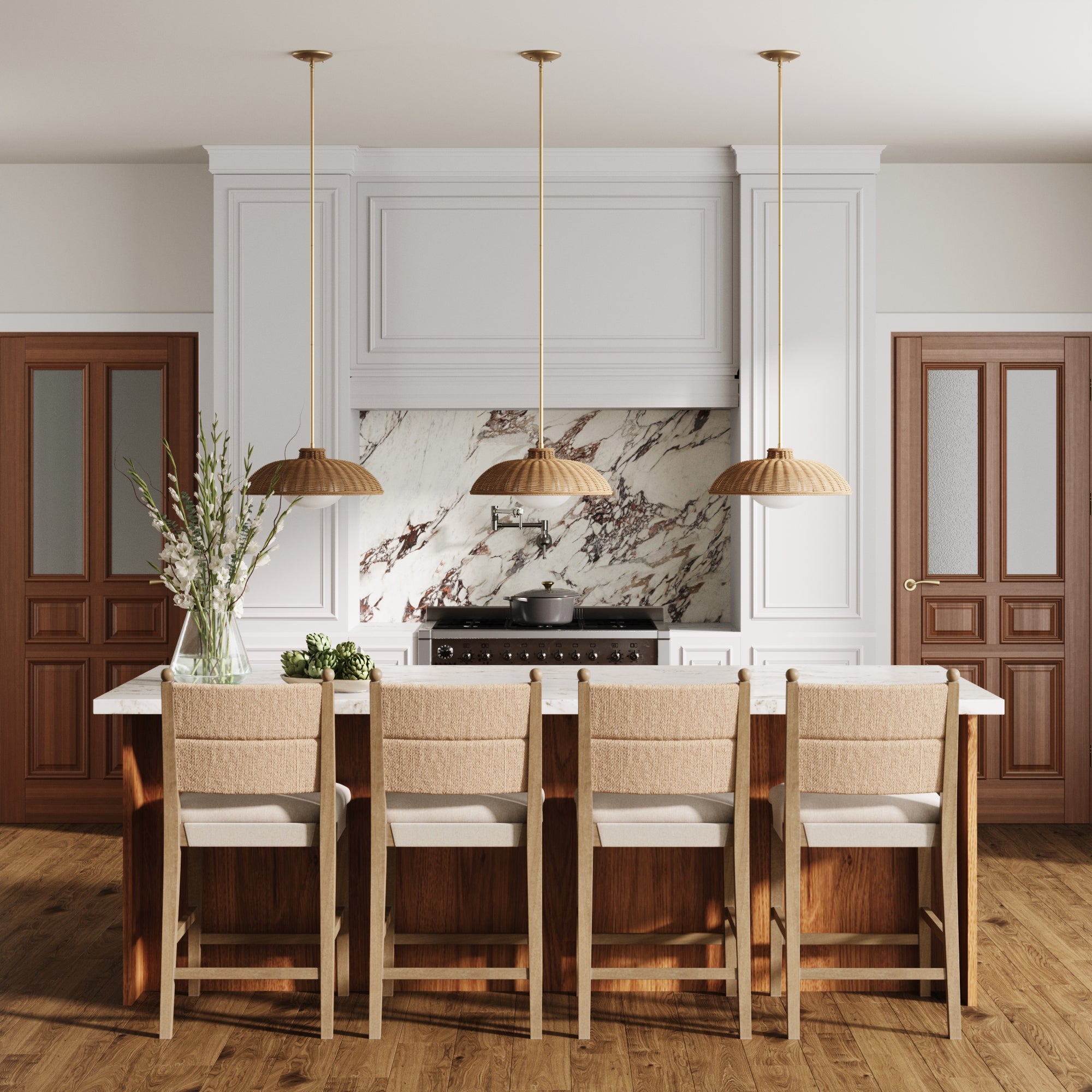 A modern kitchen boasts a large marble island with a set of four Nathan James Seagrass & Wood Counter Height Bar Stools in light brown, three pendant lights, a marble backsplash, wooden floors, two wooden doors, and a vase with flowers on the counter.