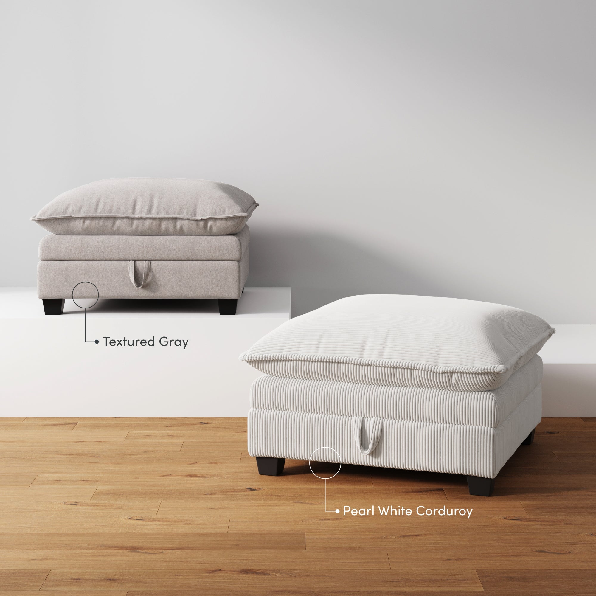 Two ottomans with cushions are displayed on a wood floor: one in textured gray on a white platform, and one in pearl white corduroy on the floor. Both have pull handles and dark block legs.
