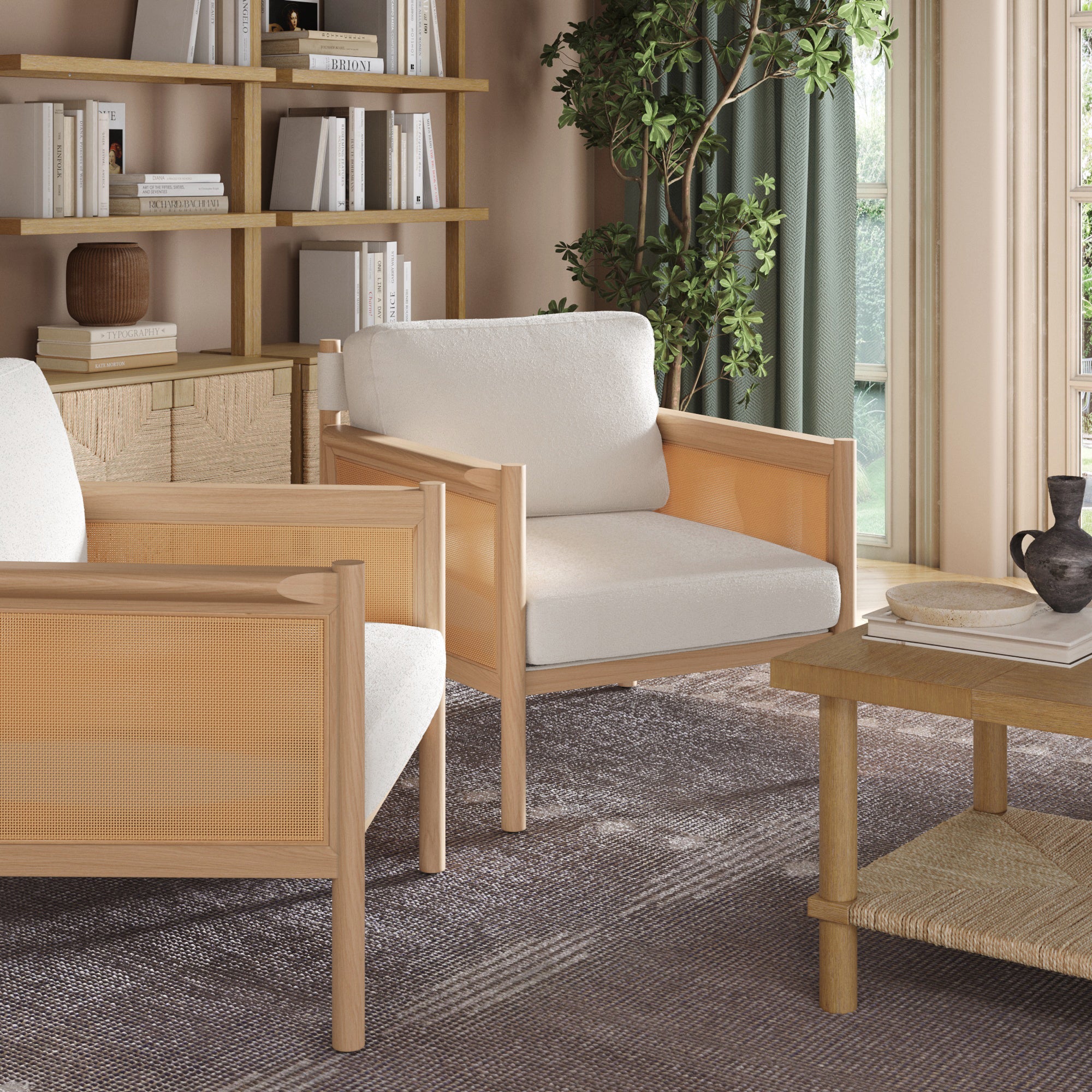A set of two Nathan James Solid Wood Boucle Accent Chairs with rattan arms and raw oak finish sit in a cozy living room with a wooden coffee table, bookshelves, decor, a potted plant, and a large window with green curtains.