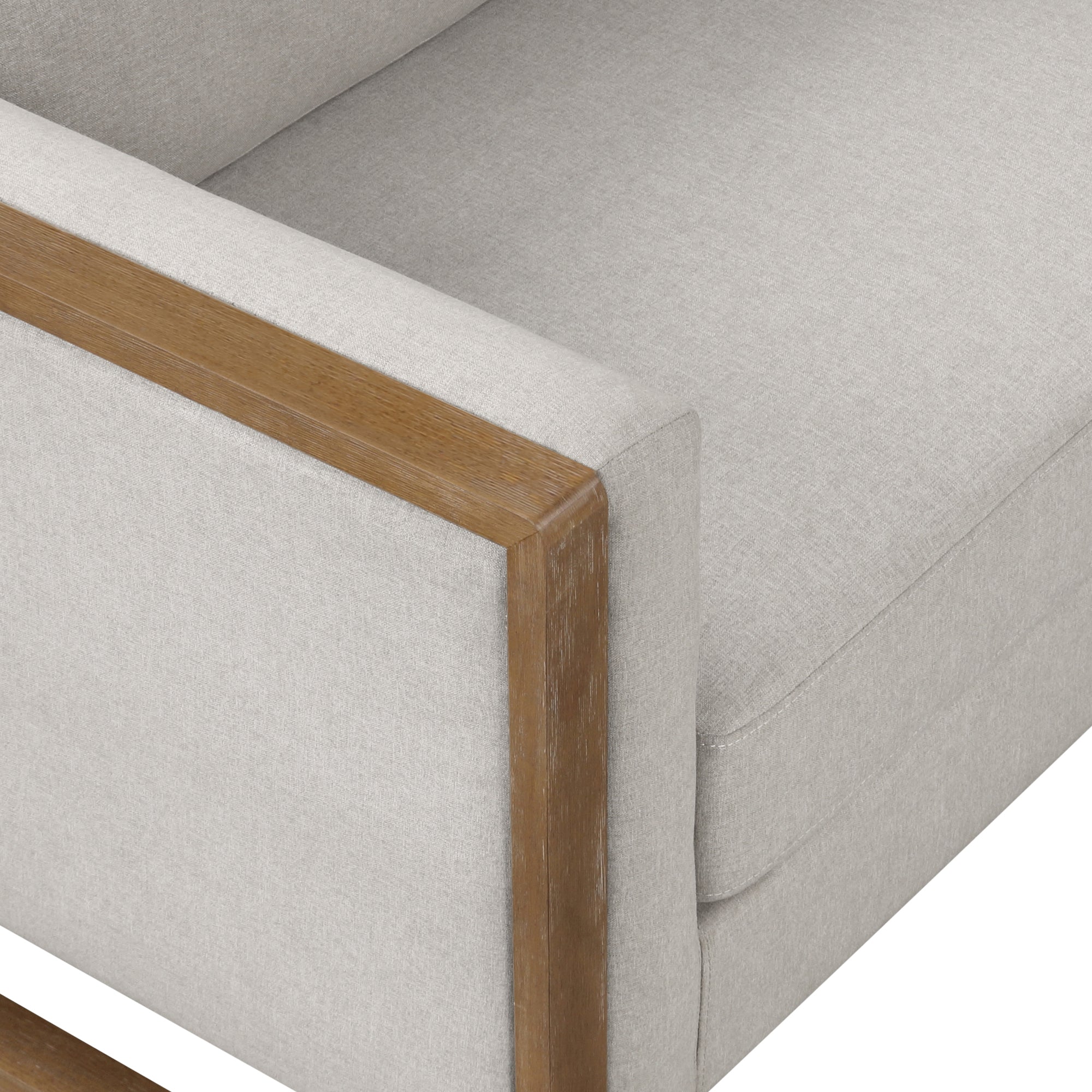 Close-up of a modern sofa featuring light gray upholstered cushions and wooden armrest detailing. The design is minimalist with clean, straight lines.