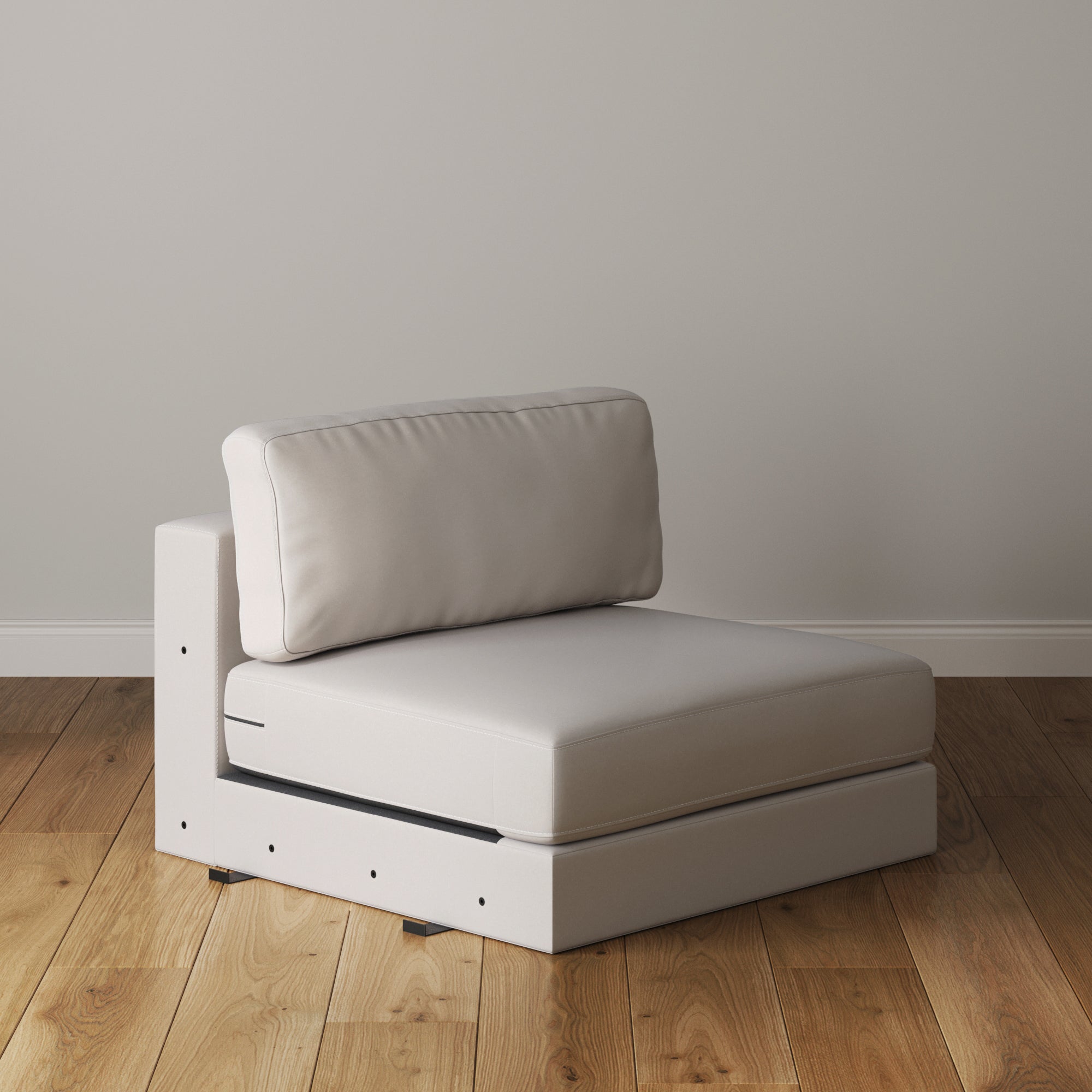 The Nathan James Upholstered Sofa Standard Seat Textured Bisque, a modern modular piece with removable cushion covers and white cushioning, sits armless on a wooden floor against a plain light gray wall.