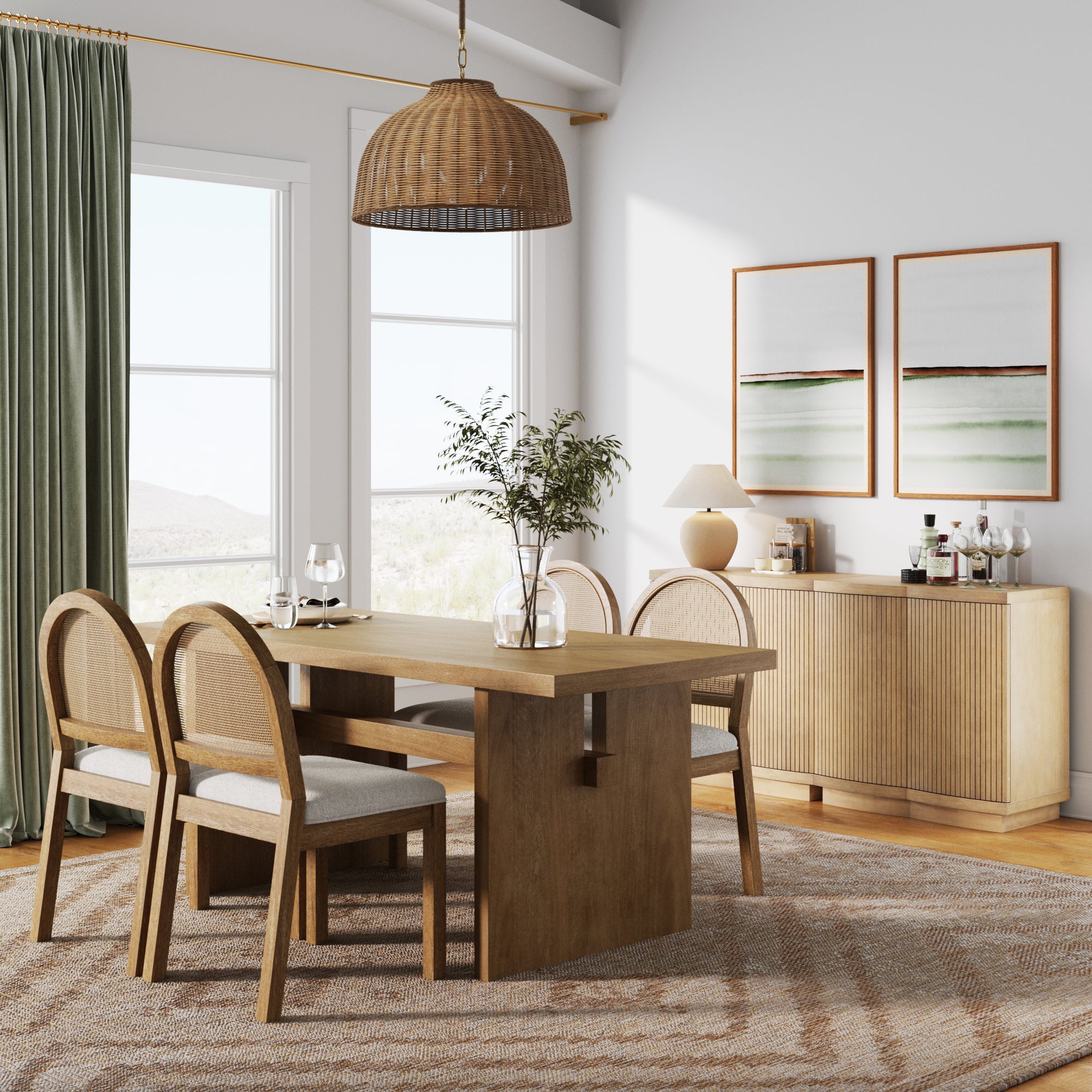 A modern dining room with a wooden table, four cushioned chairs, a wicker pendant light, a sideboard, green curtains, two framed abstract art pieces, and a patterned rug. Sunlight streams in through large windows.