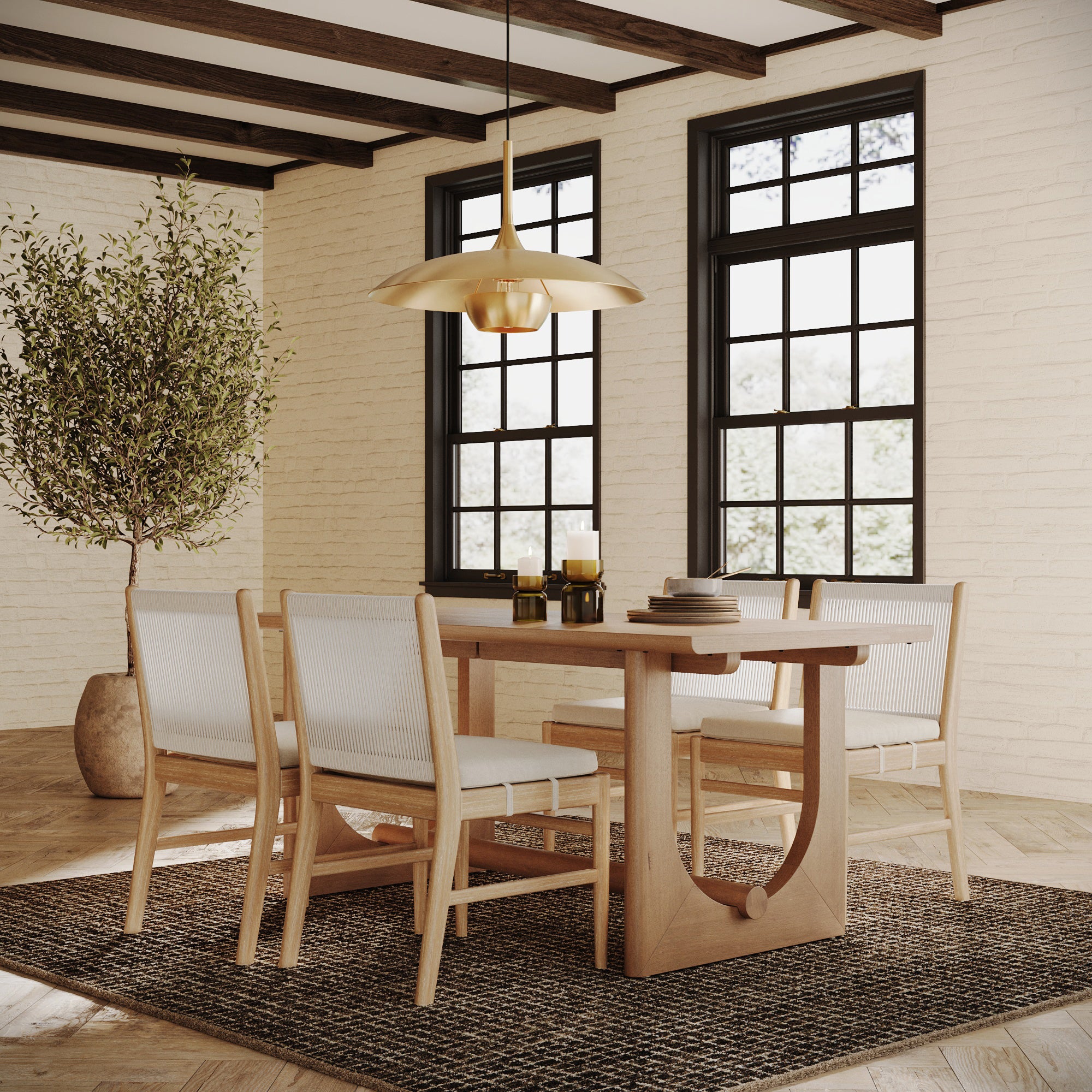 A modern dining room showcases the Nathan James Wood Dining Table for 6 with U-Shaped Legs, four chairs, a textured rug, candles, a large potted plant, black-framed windows with natural light, and a gold pendant light for mid-century charm.