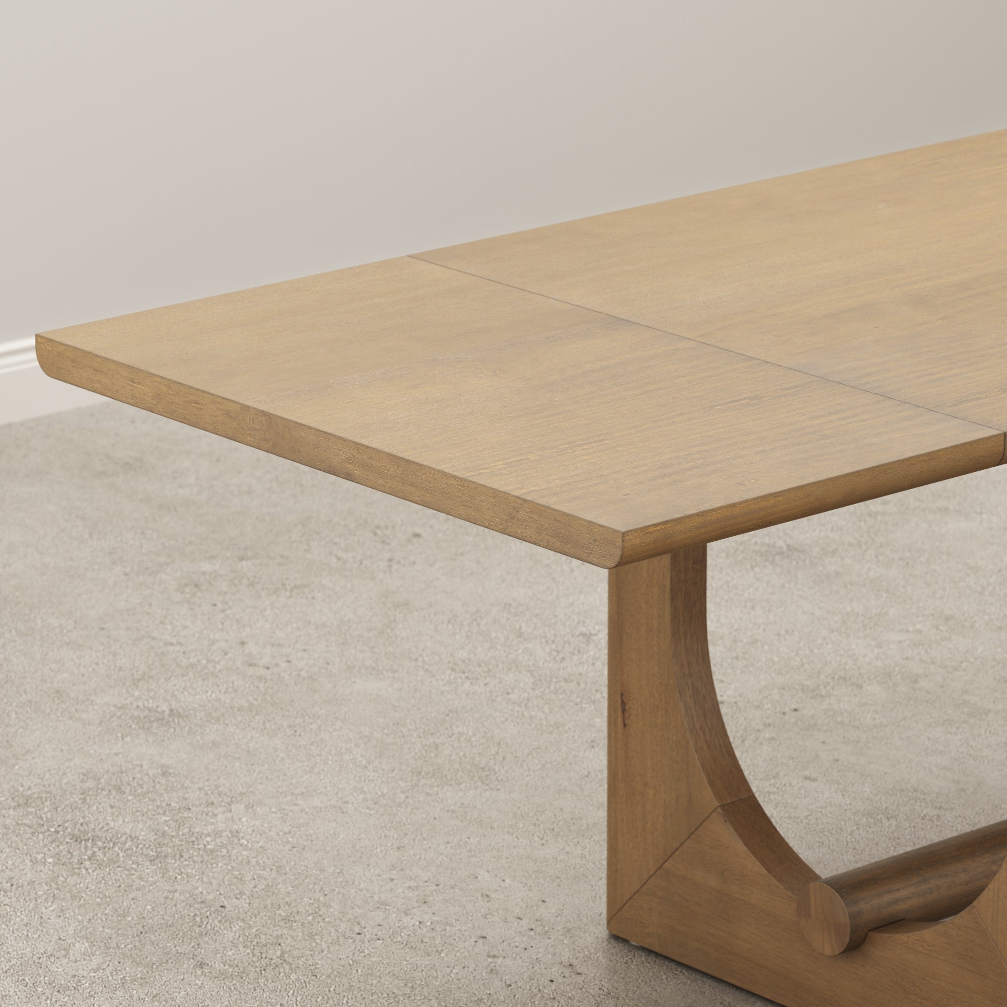 Close-up view of the underside of a wooden table with a light finish, showing the table’s edge, support beams, and part of a central leg against a plain, light background.