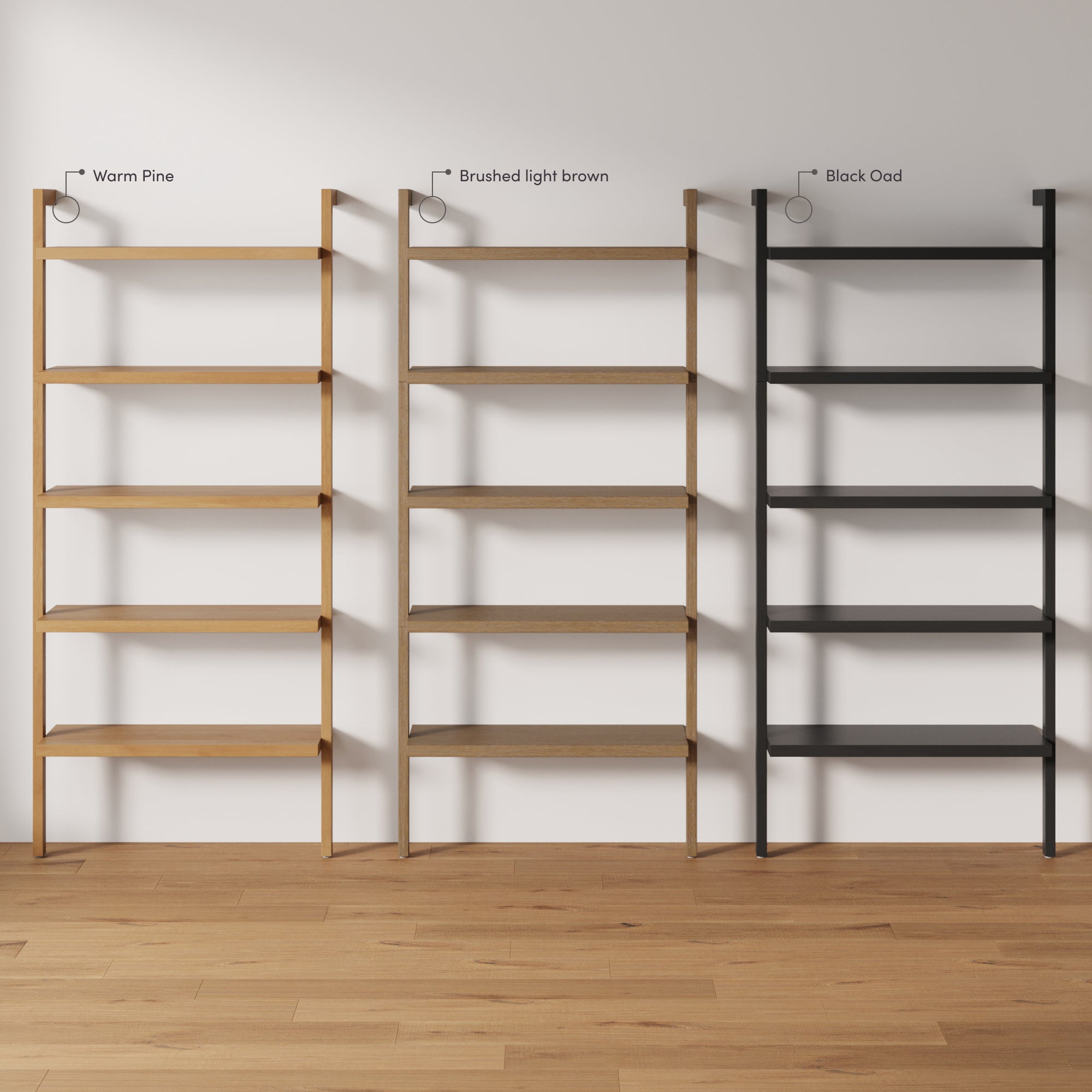 Three minimalist shelving units in different finishes—warm pine, brushed light brown, and black oak—stand side by side against a white wall on a wooden floor. Each unit has four shelves.