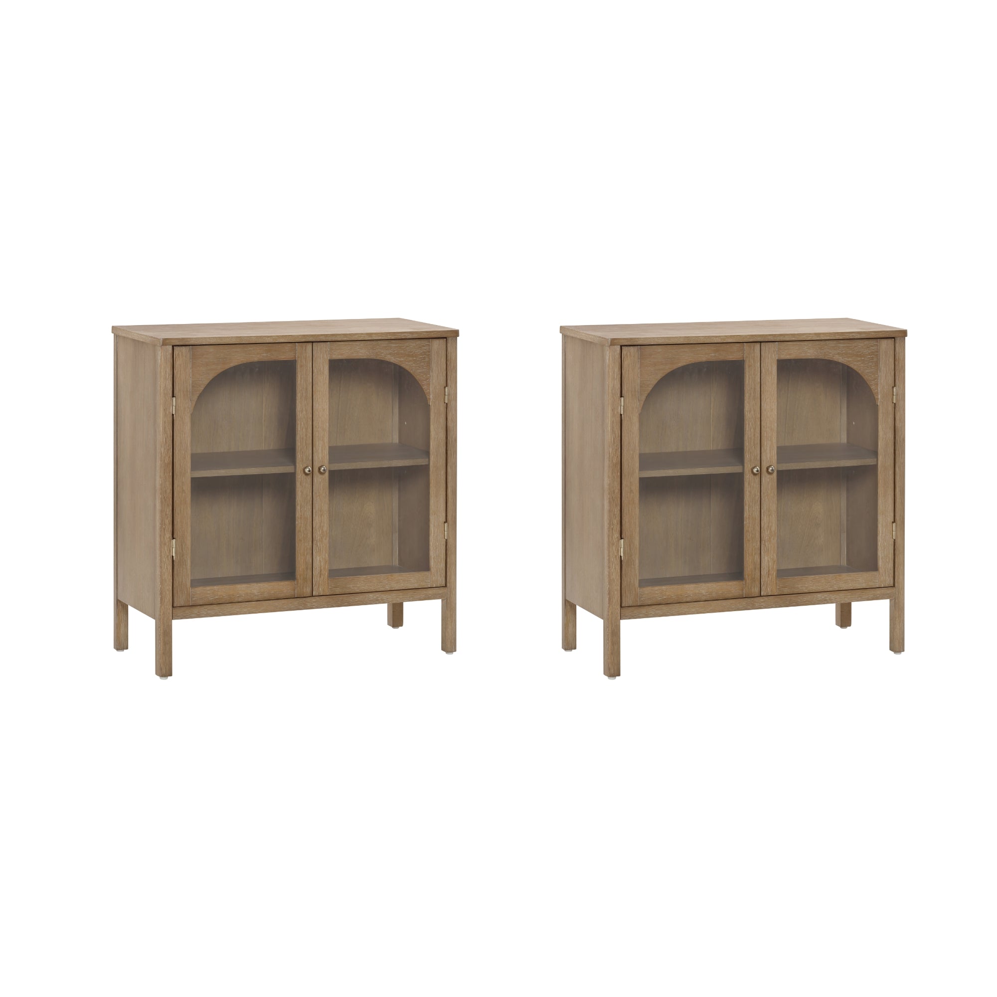 Two light wood cabinets with glass double doors and interior shelves, standing side by side on four legs each. The doors have arched frames and round metal handles.