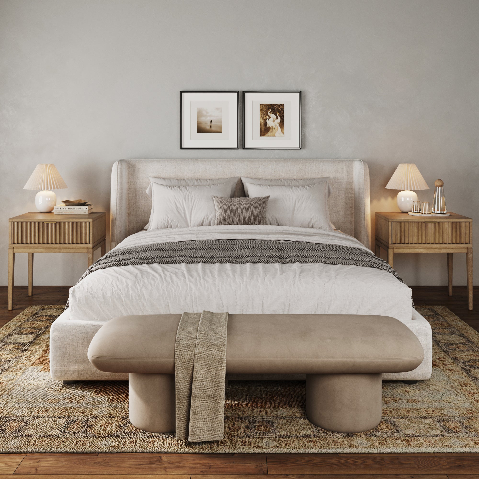 A modern, cozy bedroom with a large upholstered bed, white bedding, wooden nightstands with lamps, framed art above the bed, a soft rug, and a beige bench at the foot of the bed.