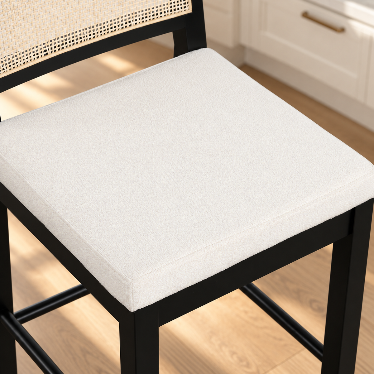 Black wooden bar stool with a woven rattan backrest and a square white upholstered seat.